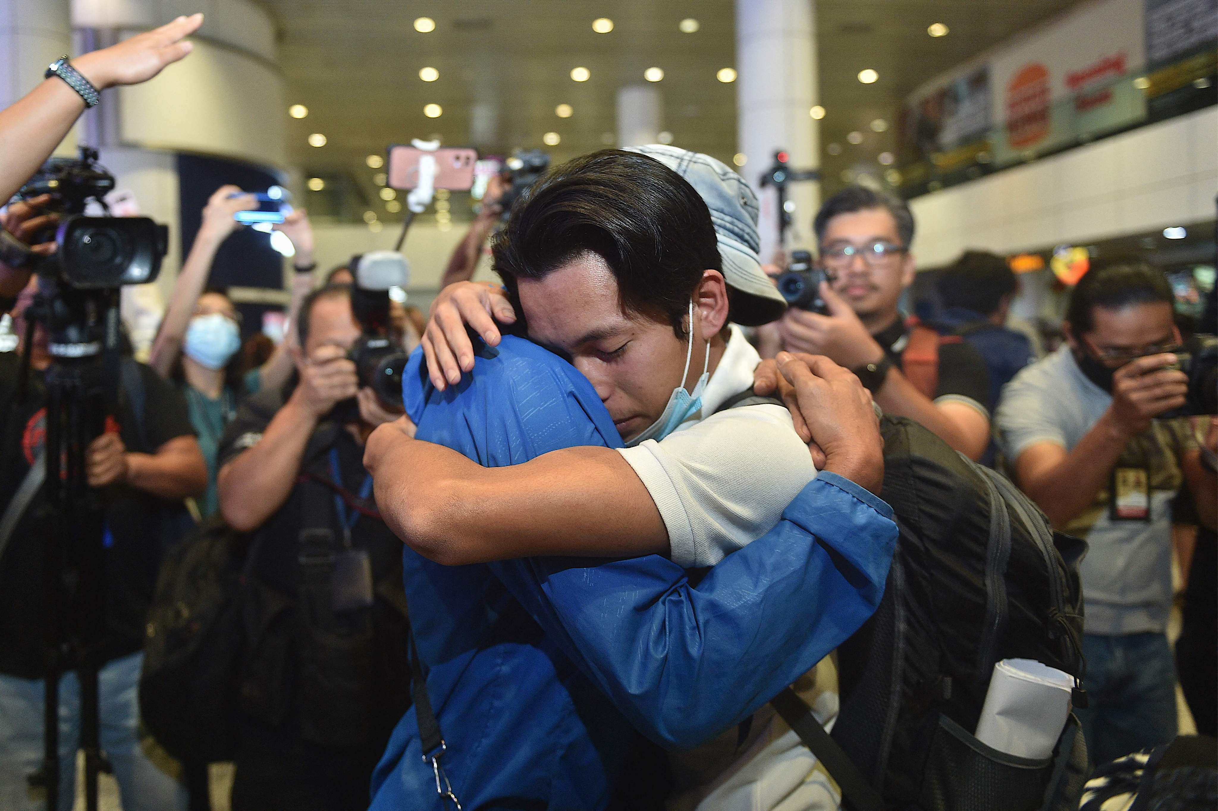 A Malaysian man rescued from a human trafficking syndicate in Myanmar is given a hug upon arrival in Kuala Lumpur in December. He said he was duped with the promise of a high salary through job adverts on social media. Photo: AFP
