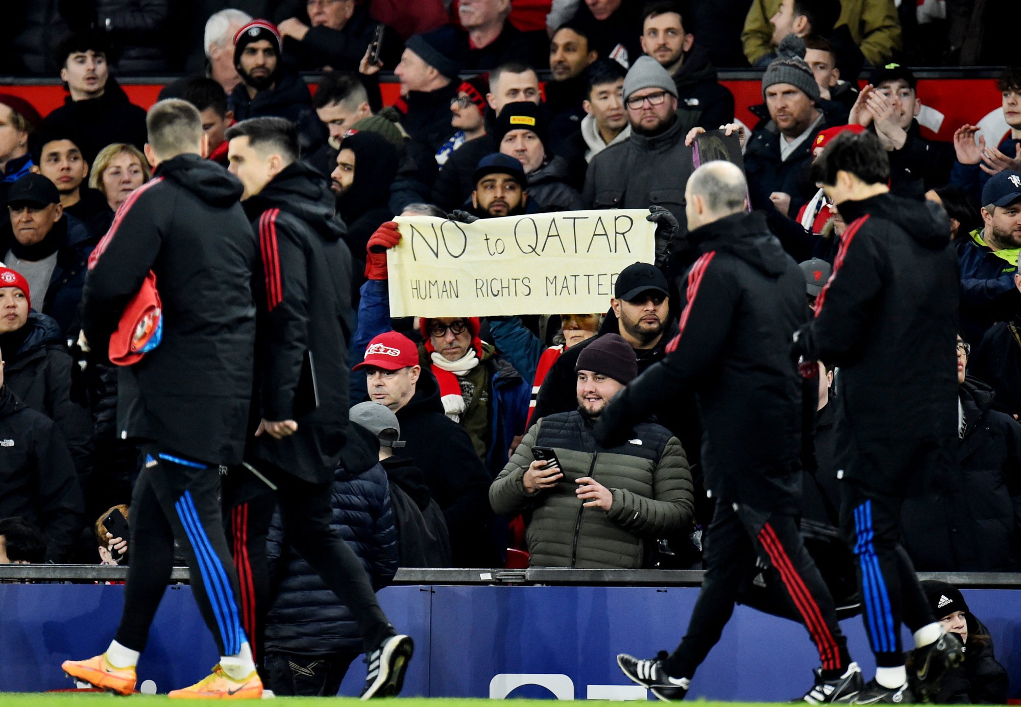Manchester United fans hold up a sign with a message saying ‘No to Qatar’. Photo: Reuters