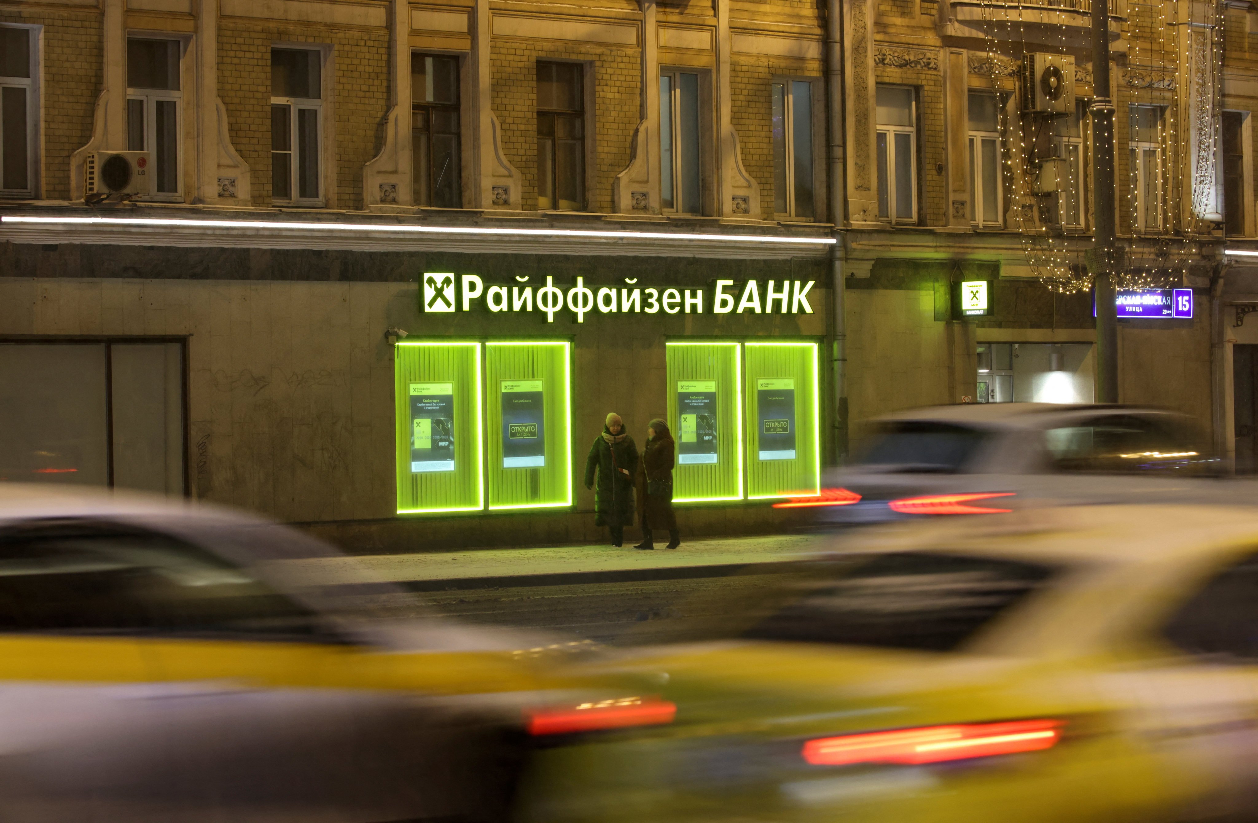 Cars drive past a branch of Raiffeisen Bank in Moscow, Russia. Photo: Reuters