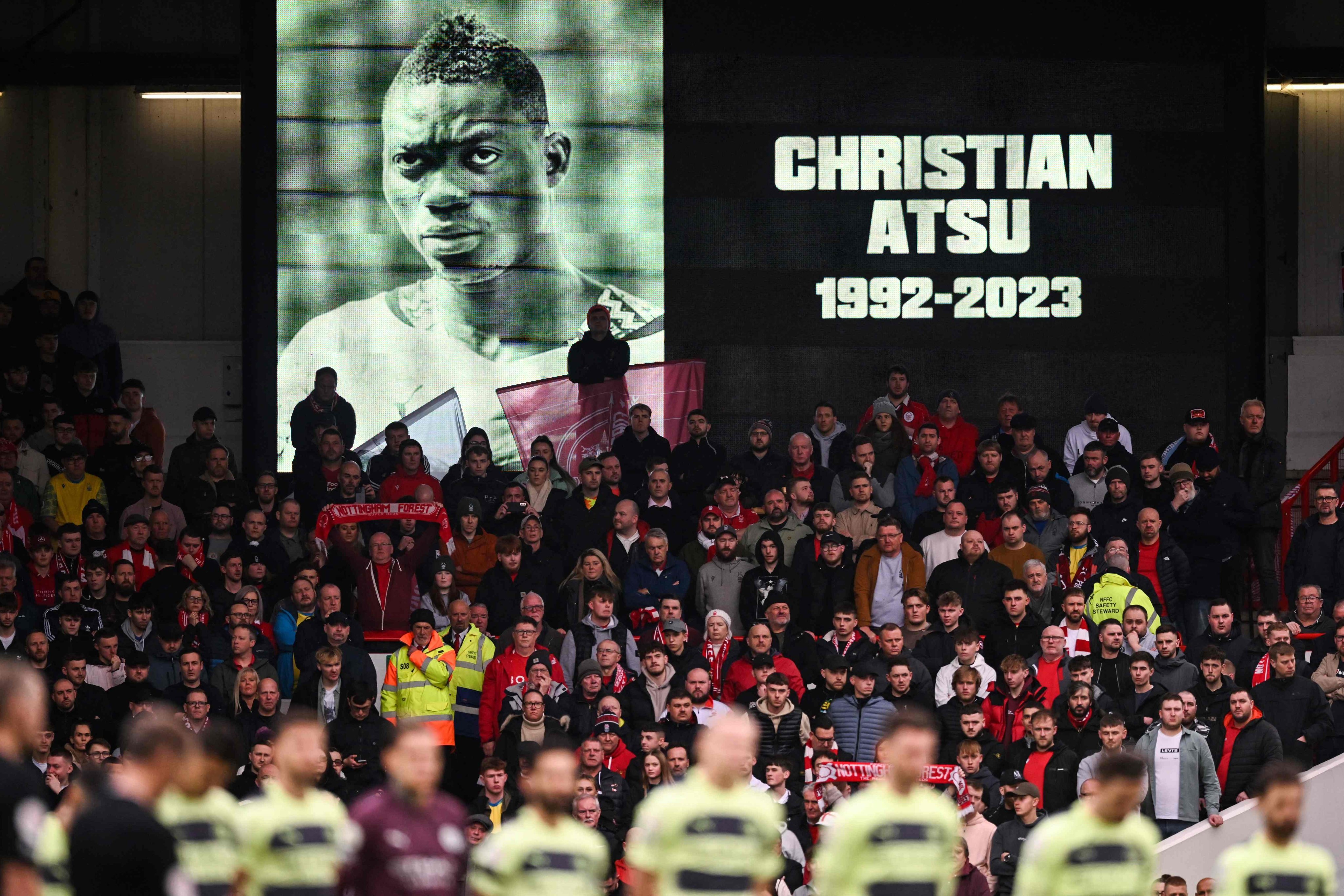 Players observe a minute of silence in tribute to Ghanaian footballer Christian Atsu, who died during the earthquake in Turkey, before the English Premier League football match between Nottingham Forest and Manchester City at The City Ground in Nottingham, UK on Saturday. Photo: AFP