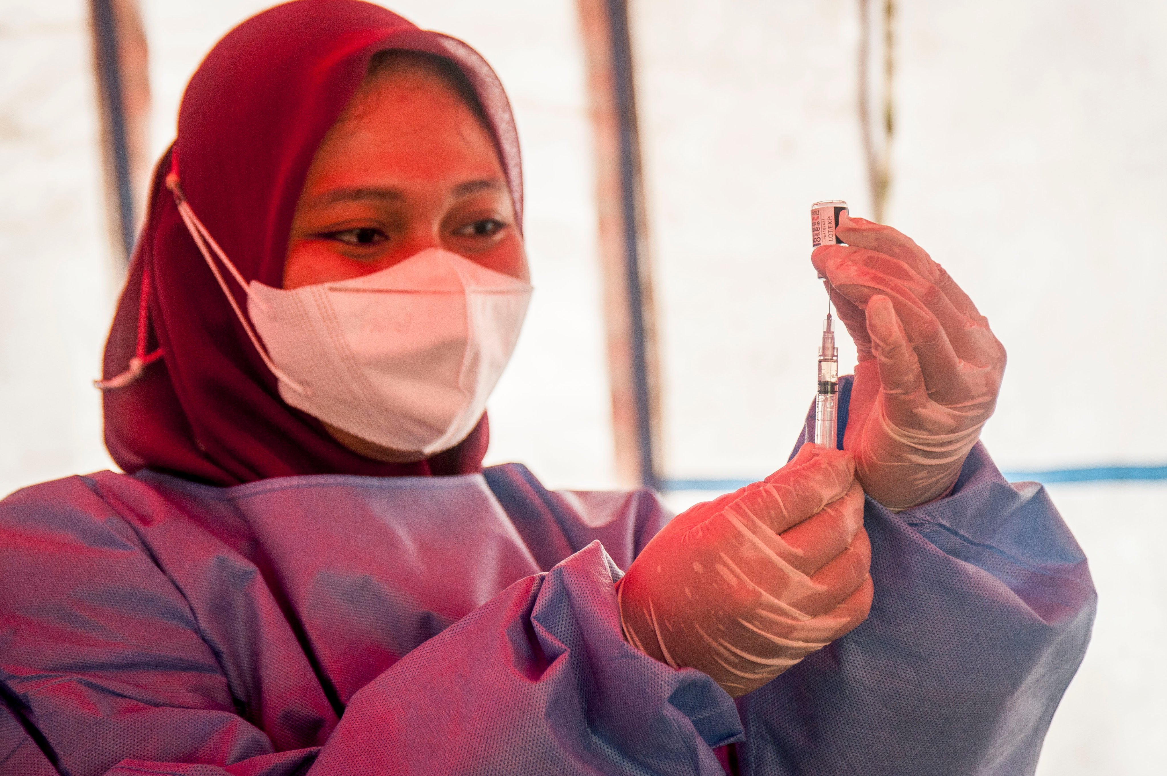 A health worker prepares a booster dose of the Covid-19 vaccine in Yogyakarta, Indonesia, on February 16. Photo: Xinhua