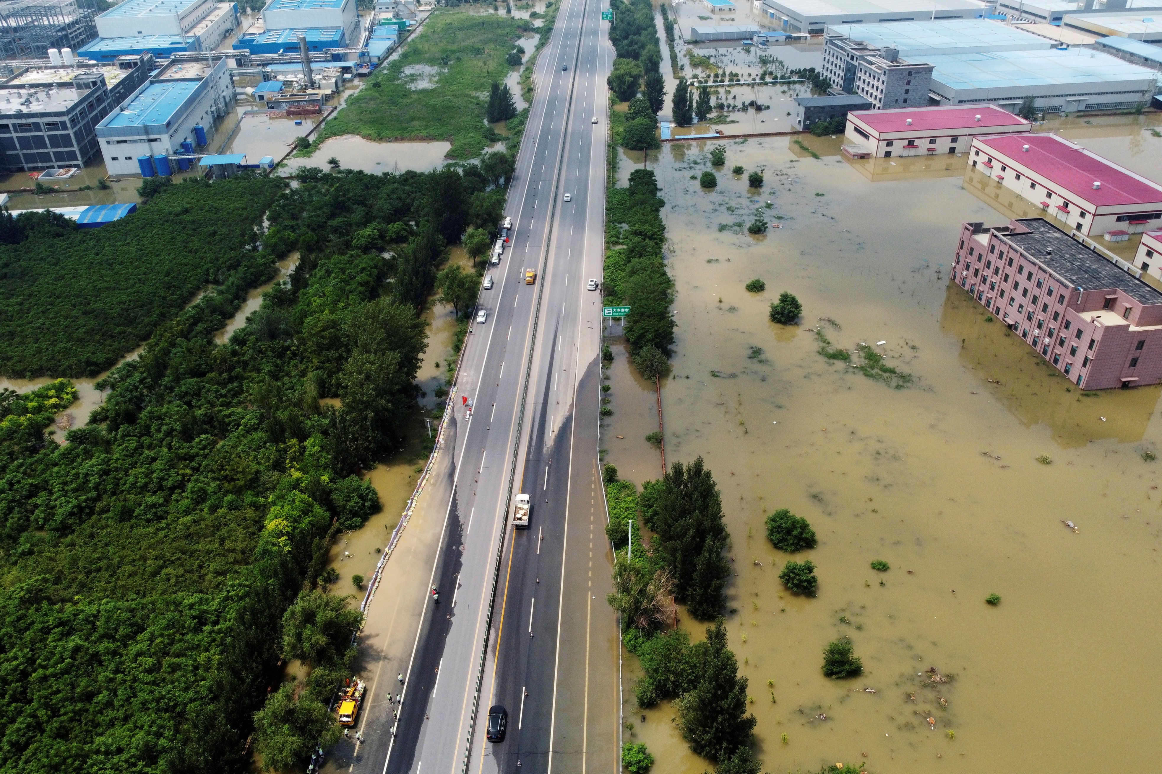 Flooded industrial buildings sit by a highway following heavy rainfall in Xinxiang, Henan province, on July 24, 2021. Augmenting public funds with private finance can help rich countries provide developing nations the help they need to avert climate change and its destructive effects. Photo: Reuters