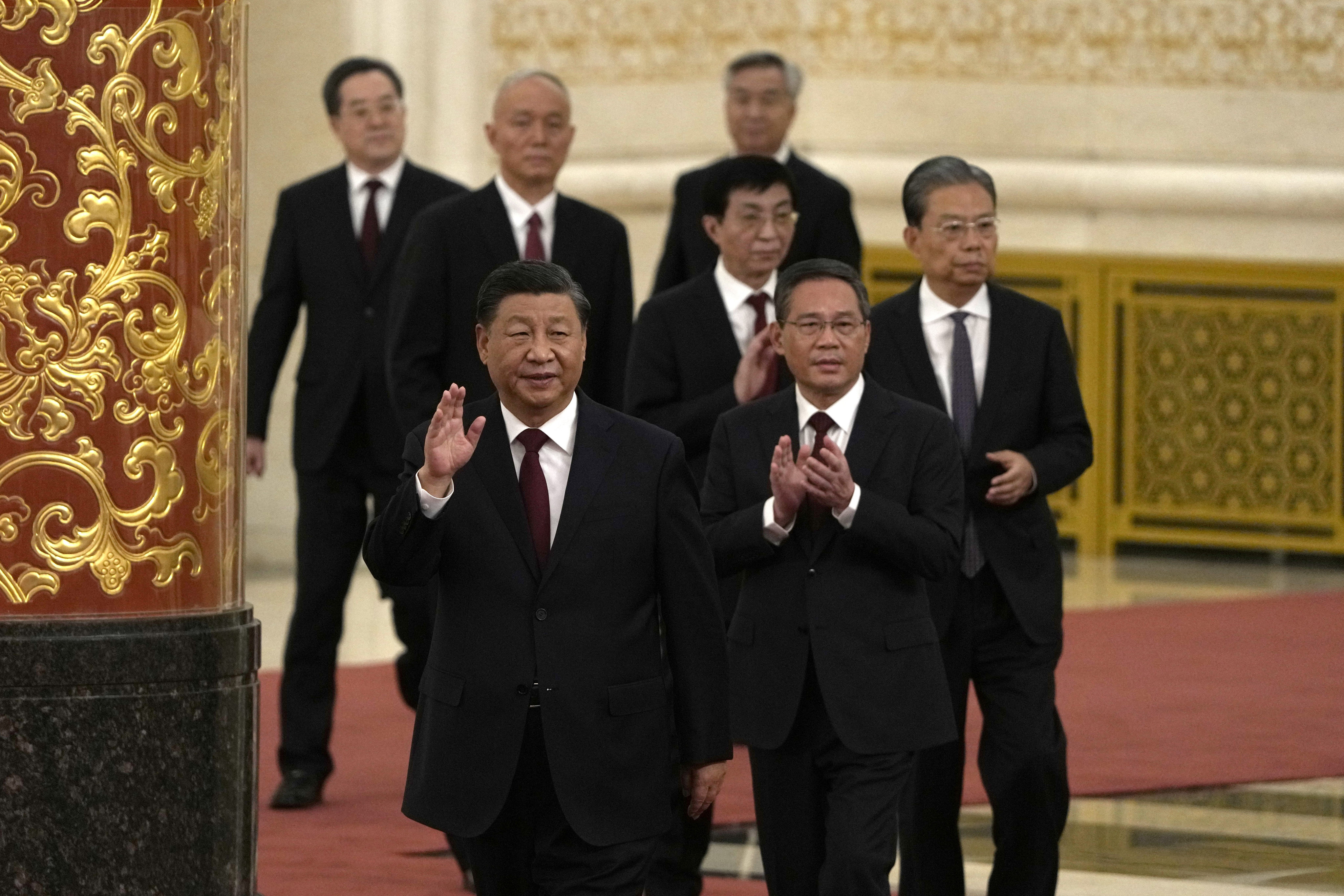 Li Qiang, tipped to be China’s next premier, and other members of the new Politburo Standing Committee follow President Xi Jinping into the Great Hall of the People in Beijing. Photo: AP