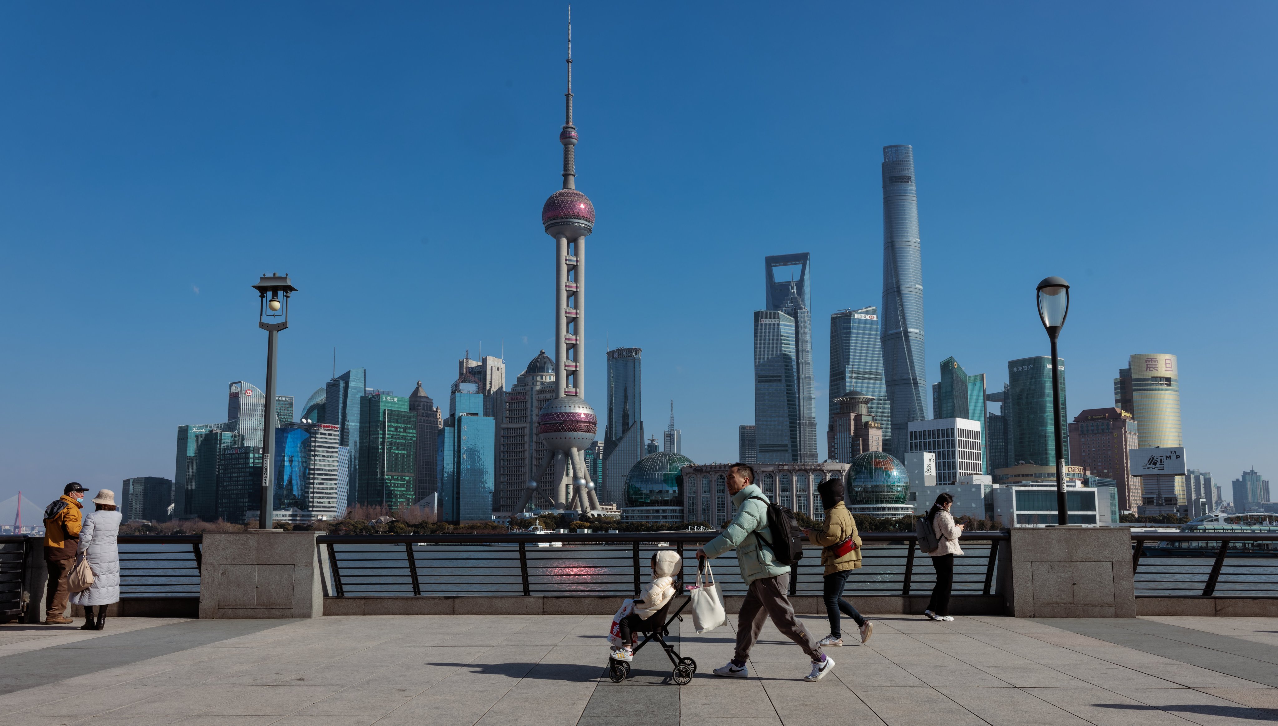 People stroll along the Bund, in Shanghai, China, on January 27. In recent decades, China’s ability to coordinate large-scale economic activity has steadily increased. Photo: EPA-EFE