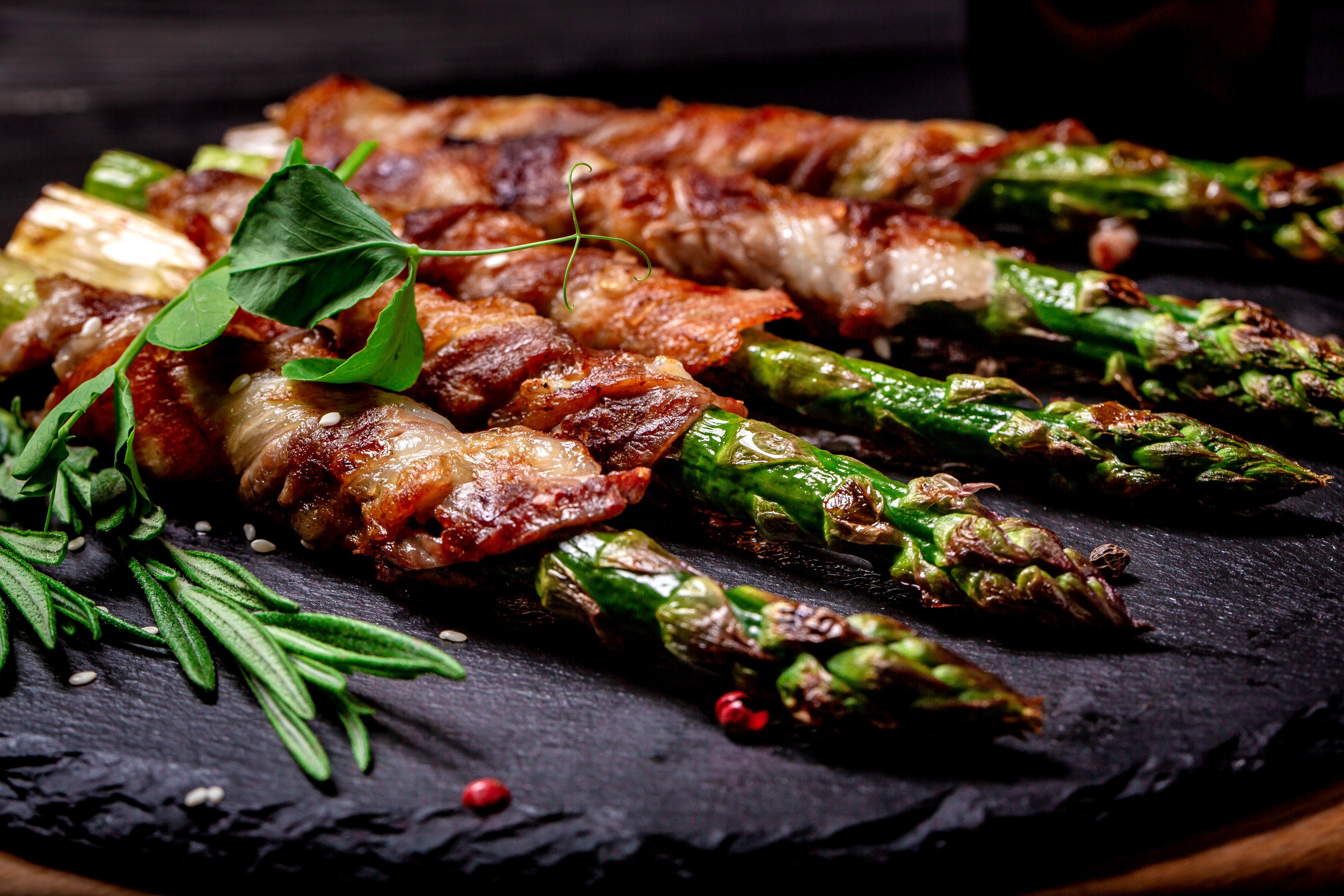 Grilled green asparagus wrapped with bacon - an overused ingredient these days, in columnist Andrew Sun’s opinion. Photo:   Shutterstock