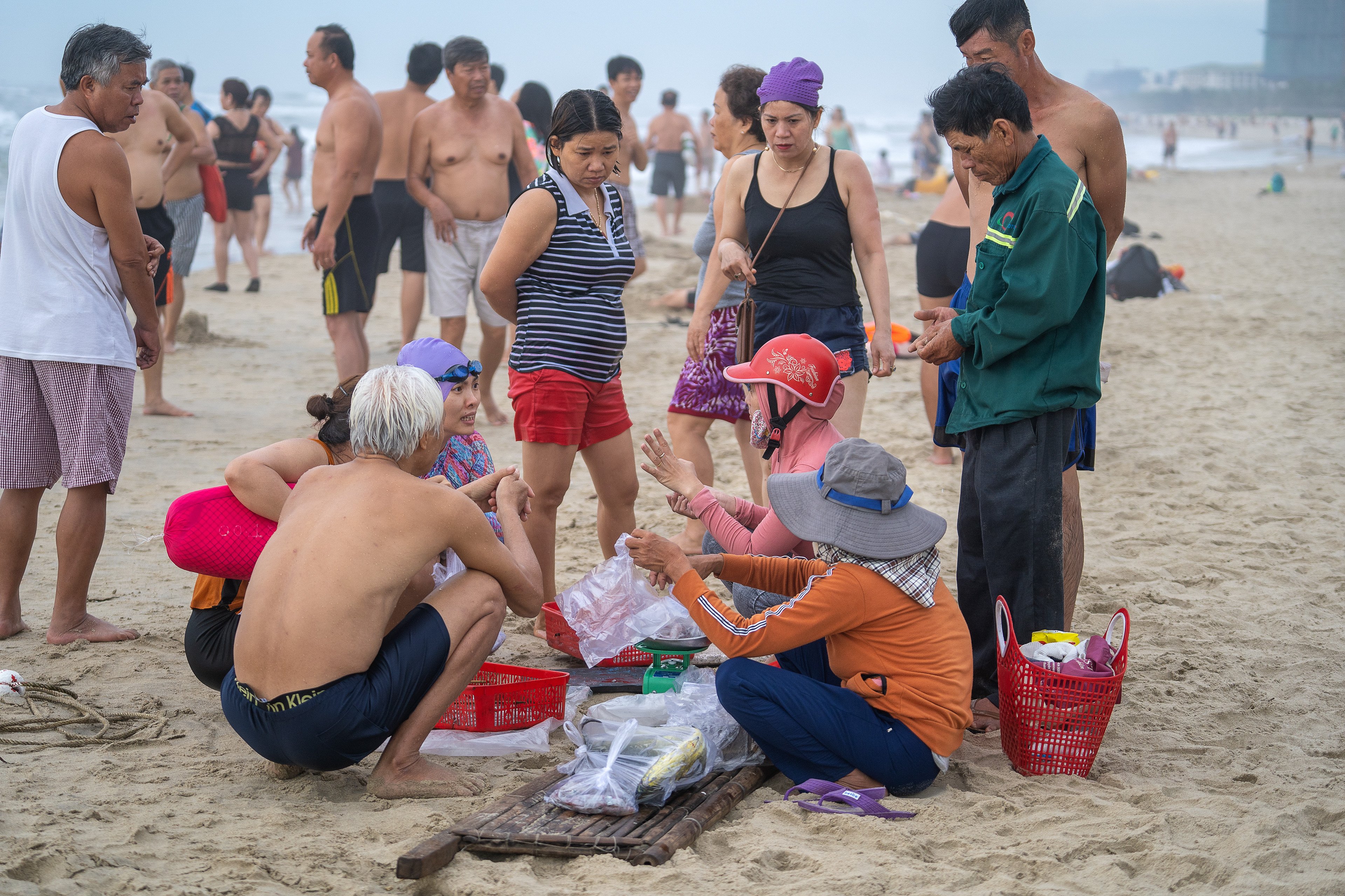 People buy seafood from local fishermen on Nam O Beach in Da Nang, Vietnam. Large quantities of rubbish left on the beach recently caused concern in the city. Photo: Shutterstock