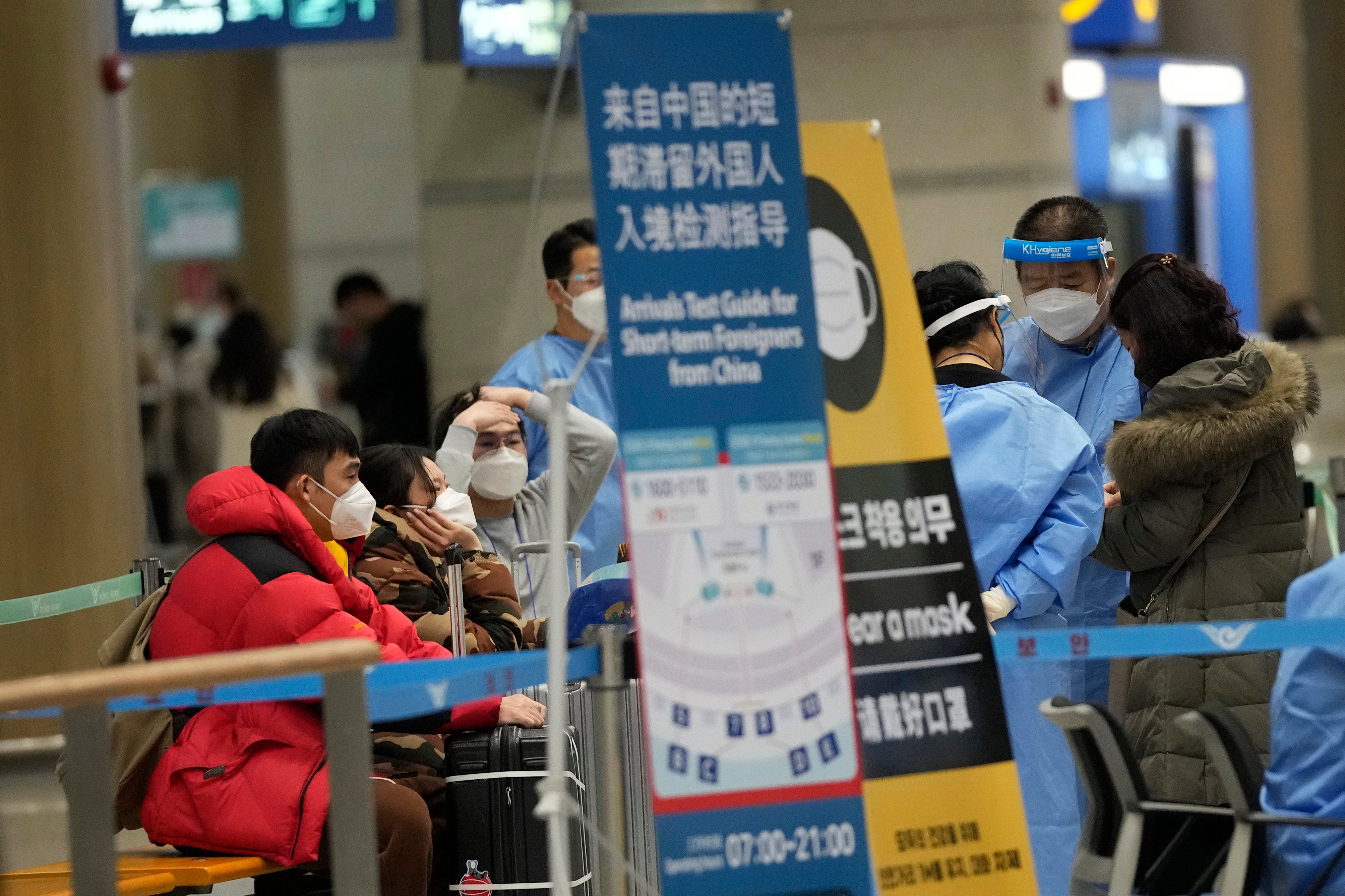 Passengers coming from China wait for Covid-19 testing upon arrival at Incheon International Airport in South Korea last month. Photo: AP