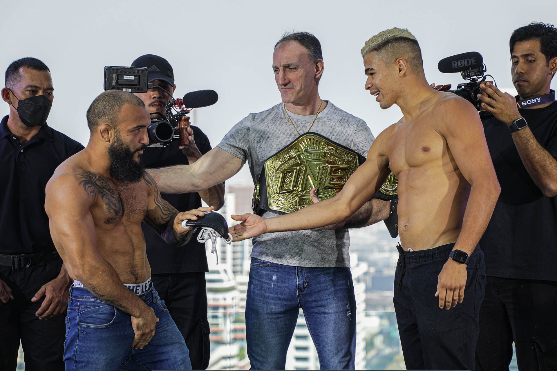 Fabricio Andrade (right) hands John Lineker a steel cup at the ONE Fight Night 7 ceremonial weigh-ins and face offs in Bangkok. Photo: ONE Championship