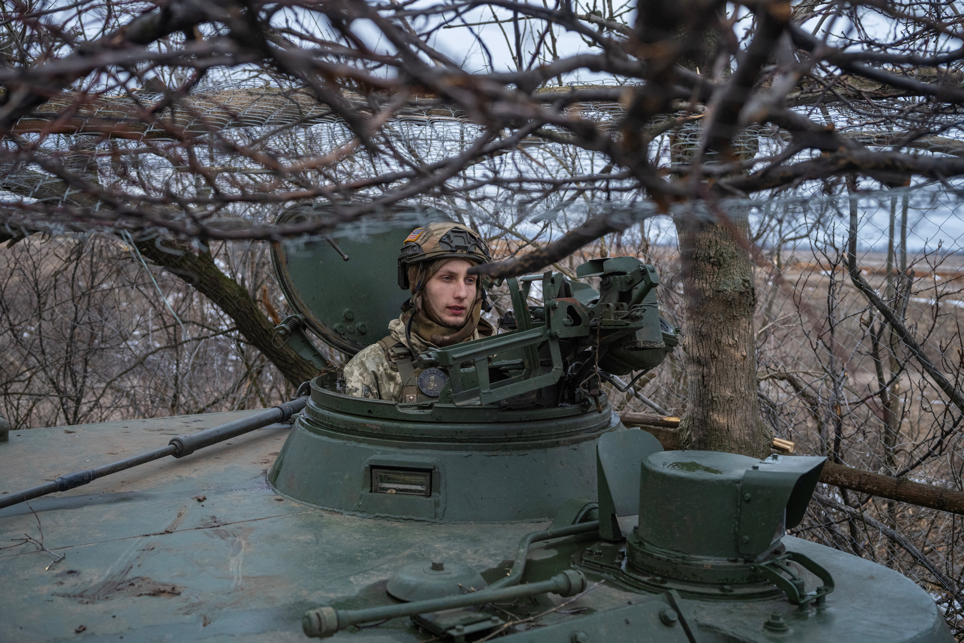 A Ukrainian serviceman sits inside a 2S3 Akatsiya self-propelled howitzer near the frontline town of Bakhmut, Ukraine on Saturday. Photo: Reuters 