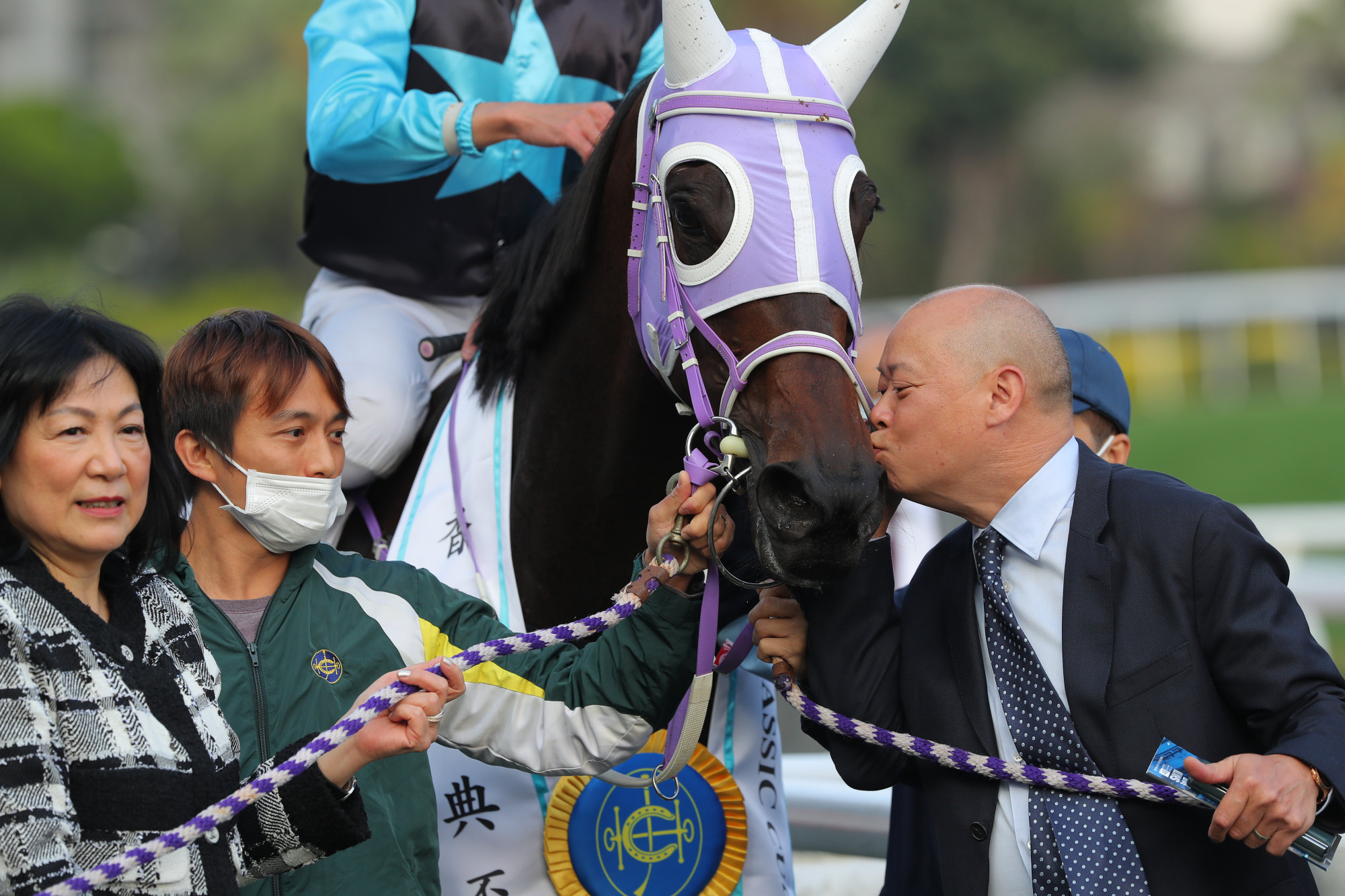 Trainer Chris So gives Super Sunny Sing a kiss after his biggest career win.