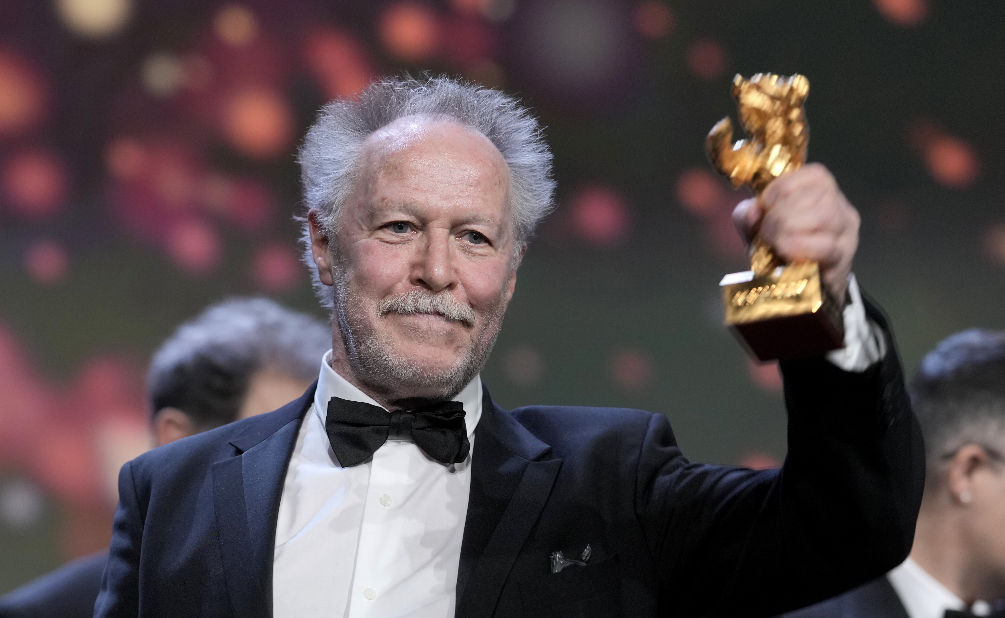 Nicolas Philibert, director of On the Adamant, receives the Golden Bear for best film during the Berlinale film festival in Berlin, Germany on Saturday. Photo: AP