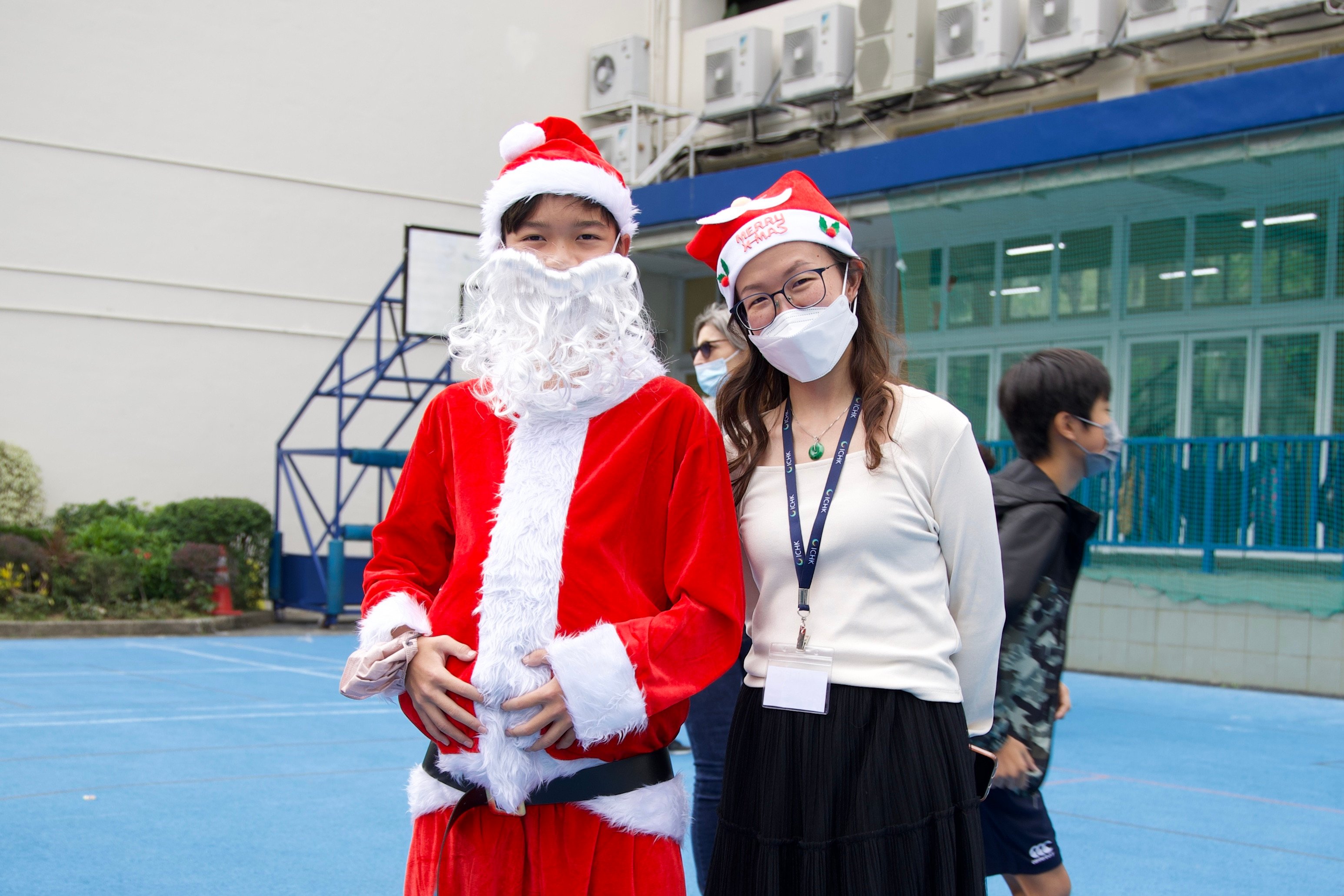 Student Reeve Ng (left) is dressed as Santa during the Christmas carnival held by the International College Hong Kong in Sha Tau Kok. Photo: Handout  