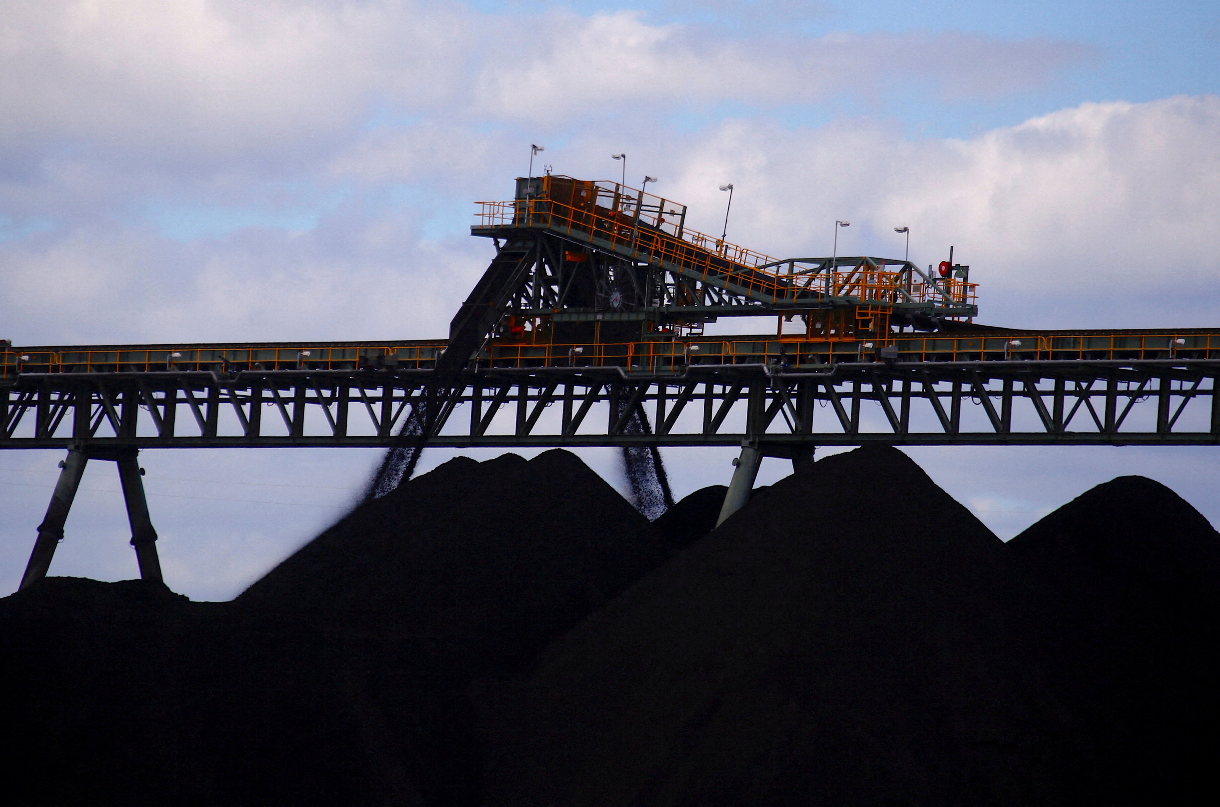 Coal is unloaded on to large piles at the Ulan Coal mines near the central New South Wales rural town of Mudgee in Australia. Photo: Reuters