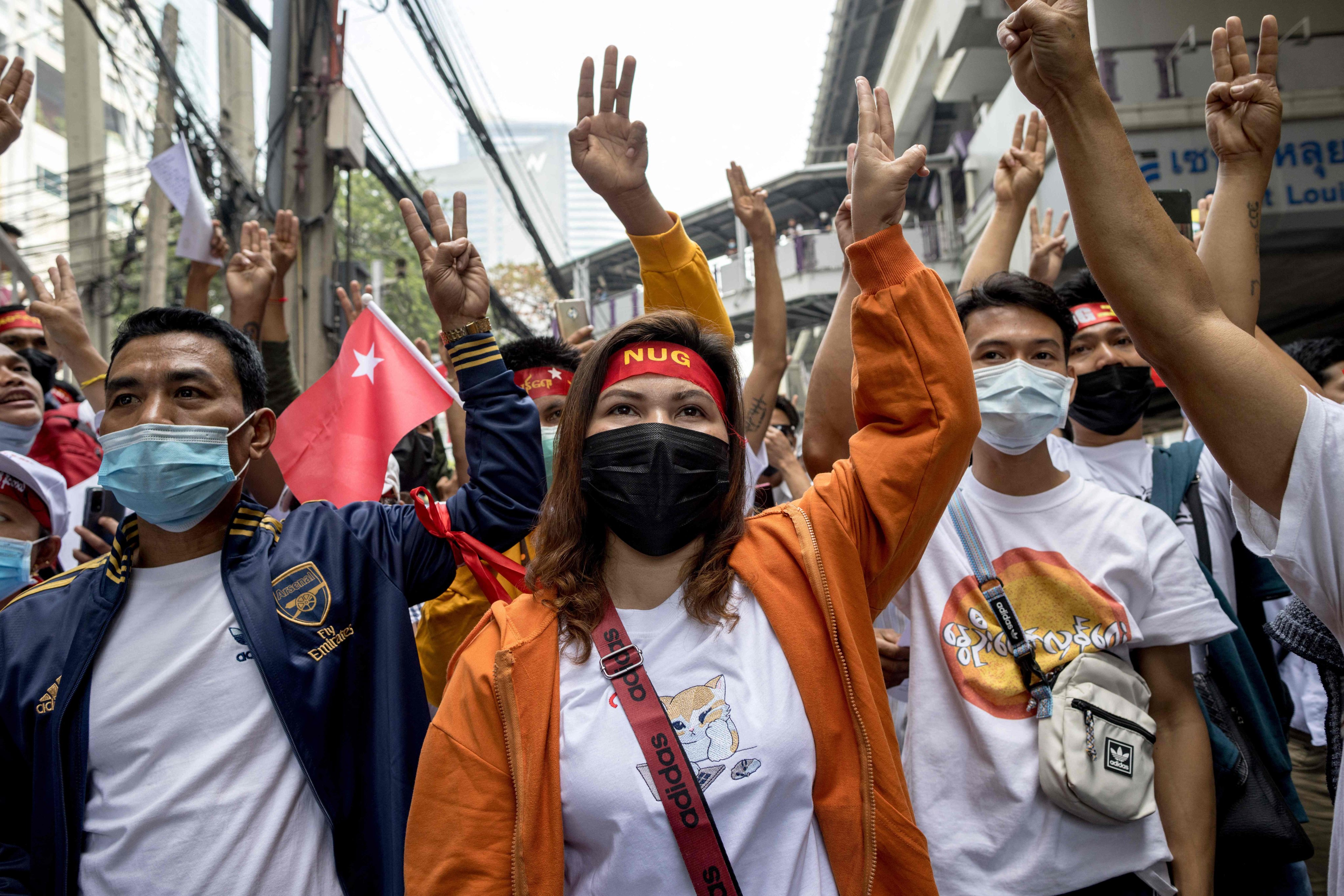 Protesters hold up three-finger salutes during a demonstration in Bangkok on February 1, 2023. Photo: AFP 