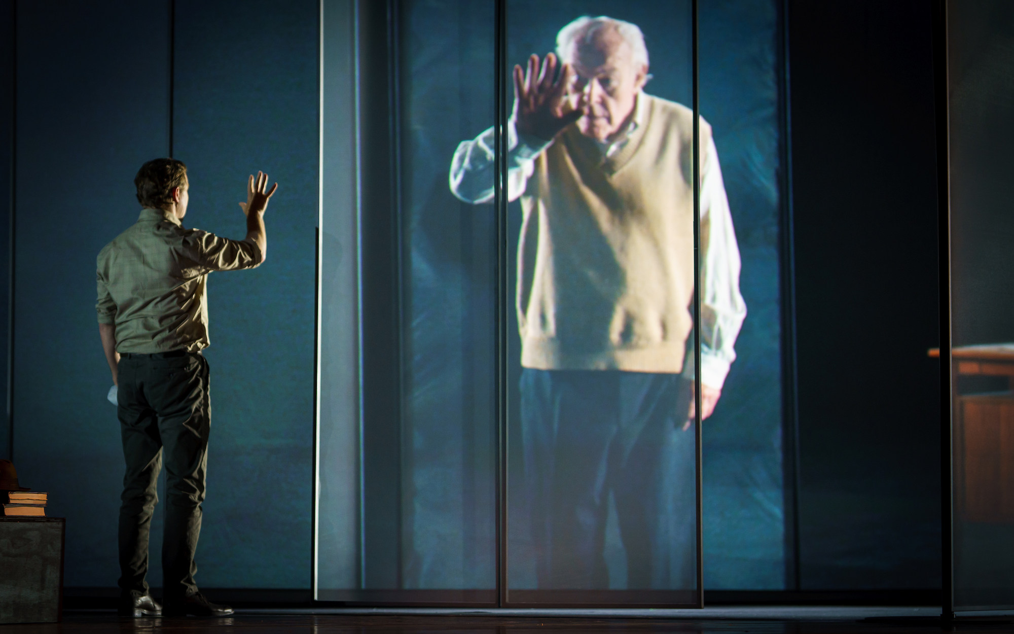 A scene from “The Book of Water” featuring Samuel West (live on stage) and his father, Timothy West (in a pre-recorded video), a polished multimedia spectacle about natural disaster and personal renewal performed in Hong Kong as part of the Hong Kong Arts Festival. Photo:  Michel Schnater 