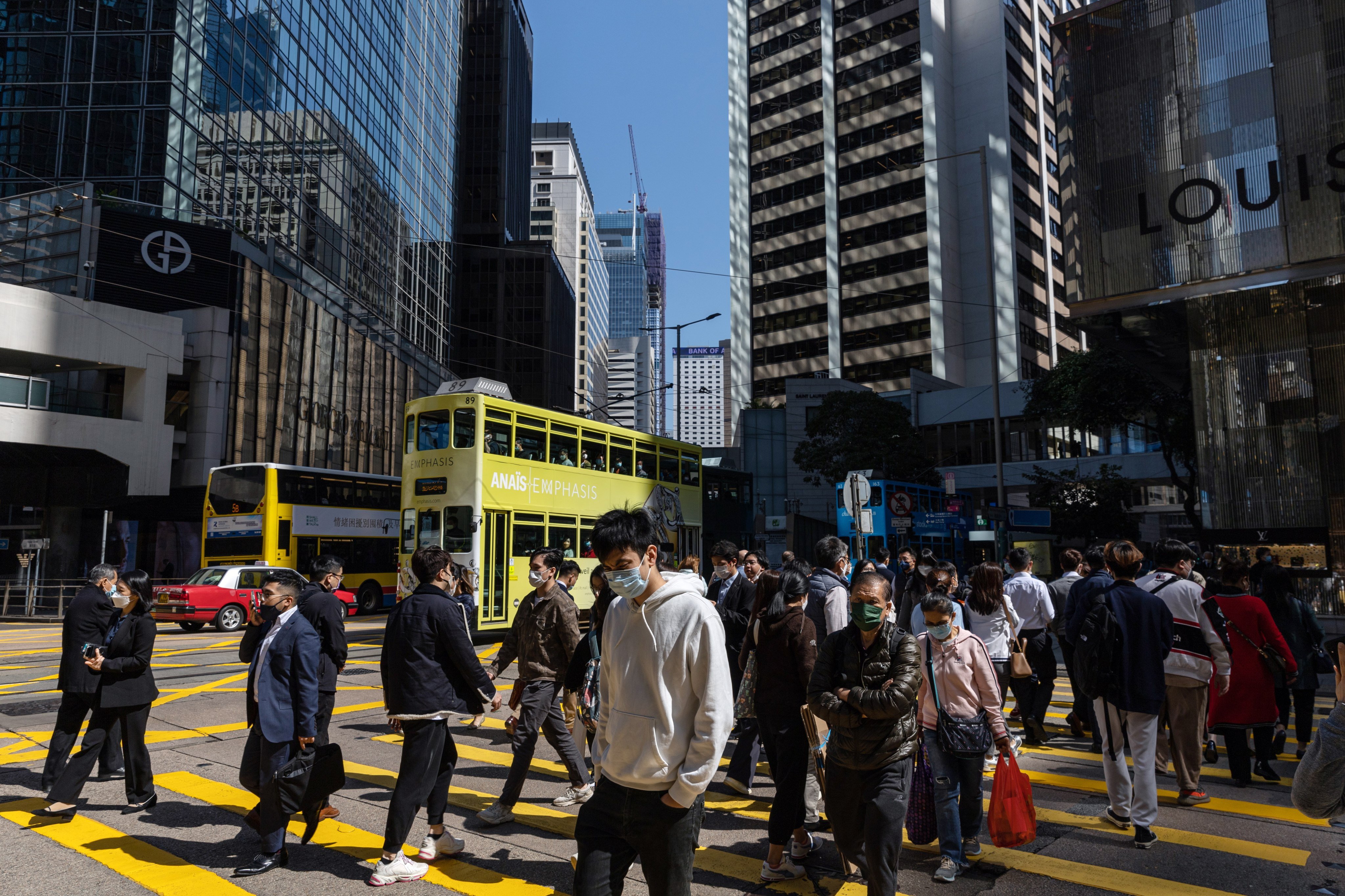 Pedestrians cross an intersection in Hong Kong on February 22. Hong Kong’s finance chief has unveiled a HK$761 billion budget, plunging into the coffers to support the city’s post-Covid recovery. Photo: EPA-EFE