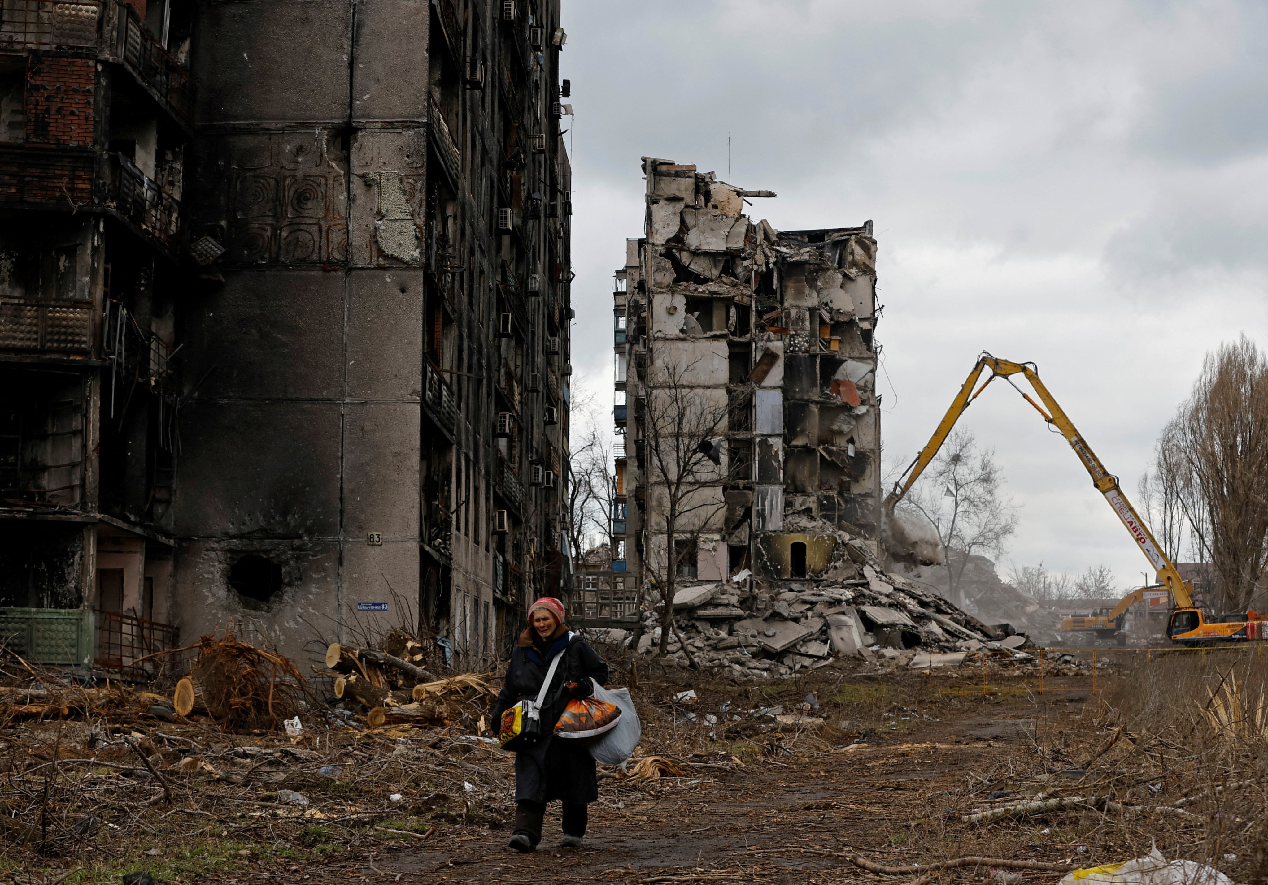 A woman walks past destroyed apartment blocks in her neighbourhood in Mariupol in Russian-controlled Ukraine, on February 15. Photo: Reuters 