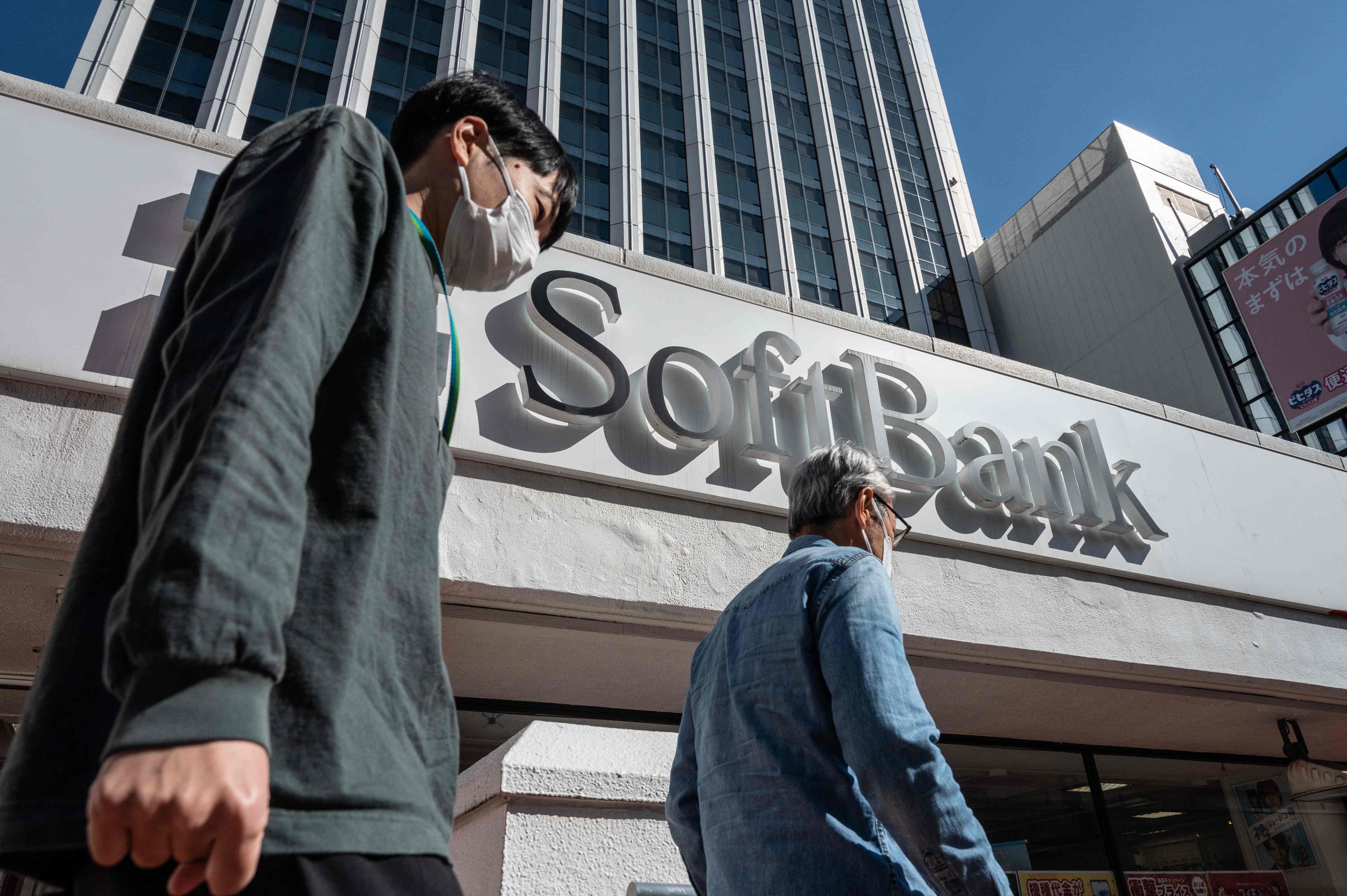 People are seen walking past a mobile shop of Japan’s SoftBank Group Corp in Tokyo on February 6, 2023. Photo: Agence France-Presse