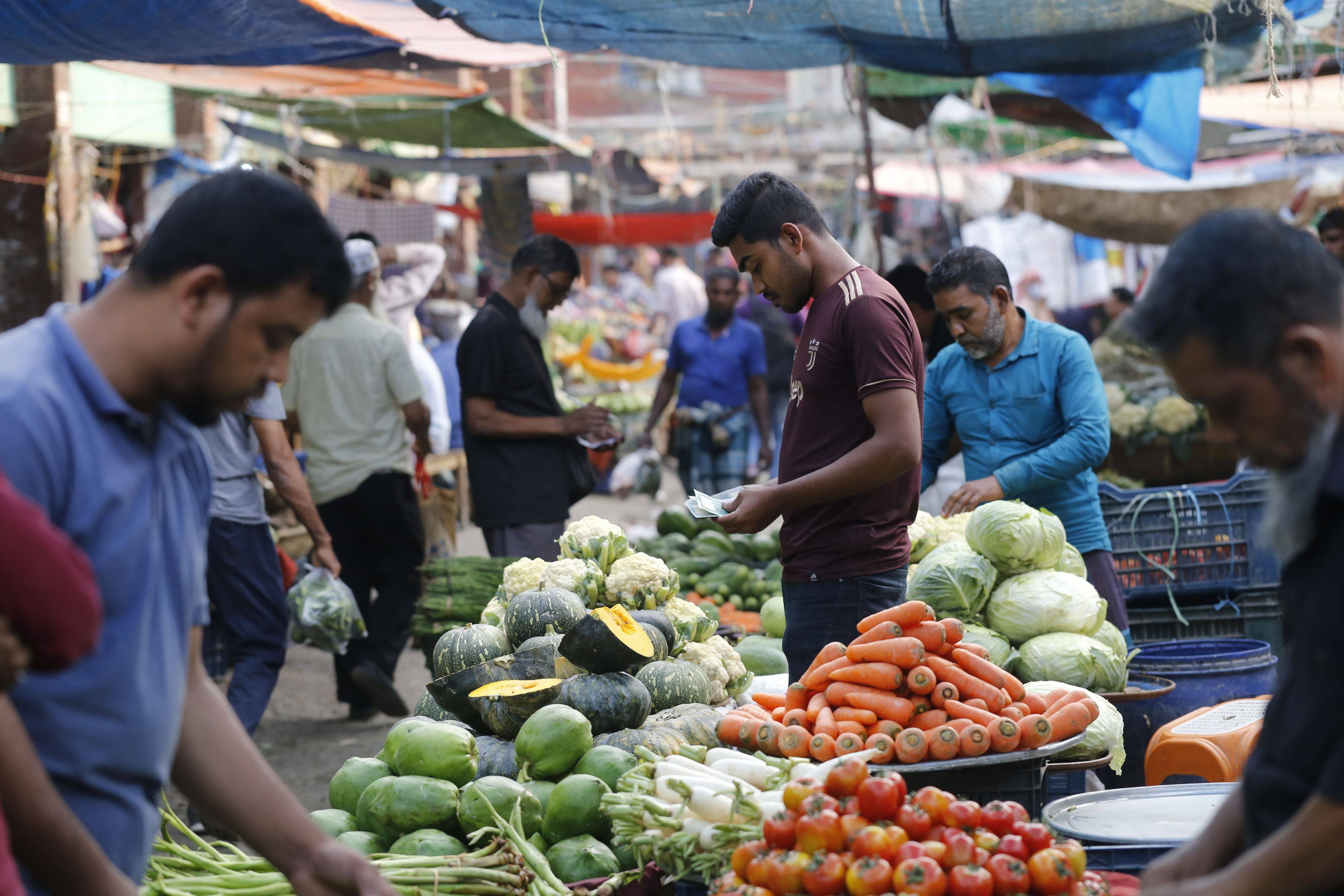 Shoppers buy produce at a market in Bangladesh. Photo: Rehman Asad
