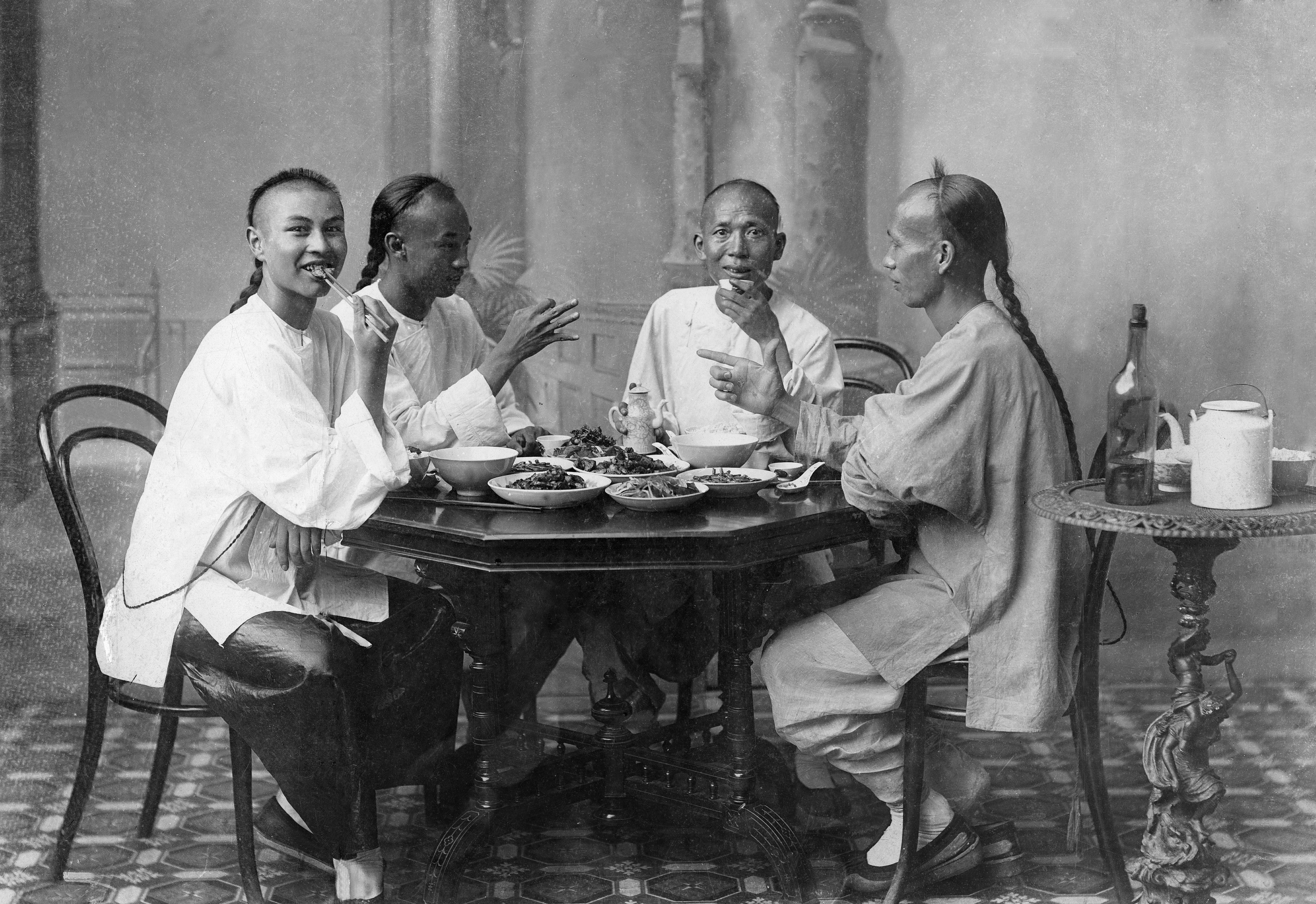 Chinese men wear the typical Manchu hairstyle, which required shaving parts of the head and wearing the remaining hair as a braid down the back, circa 1900. Picture: Getty Images