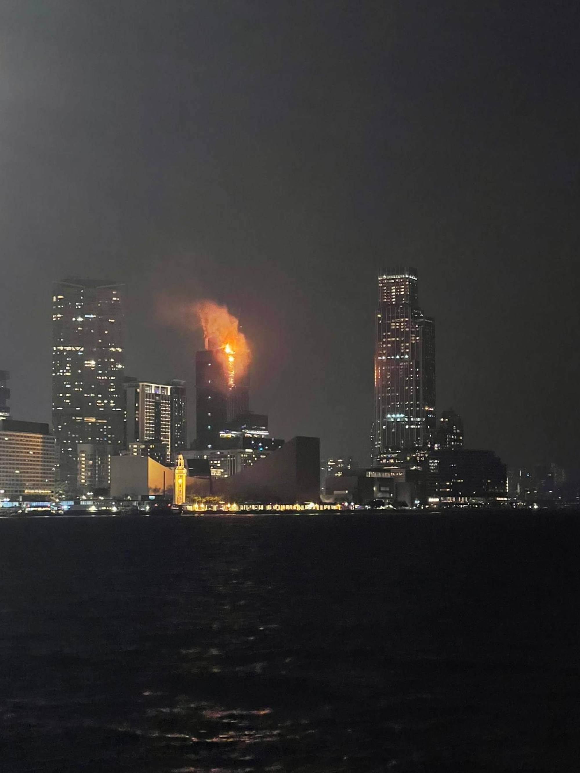 A fire at an under-construction skyscraper lights up the city's skyline. Photo: SCMP