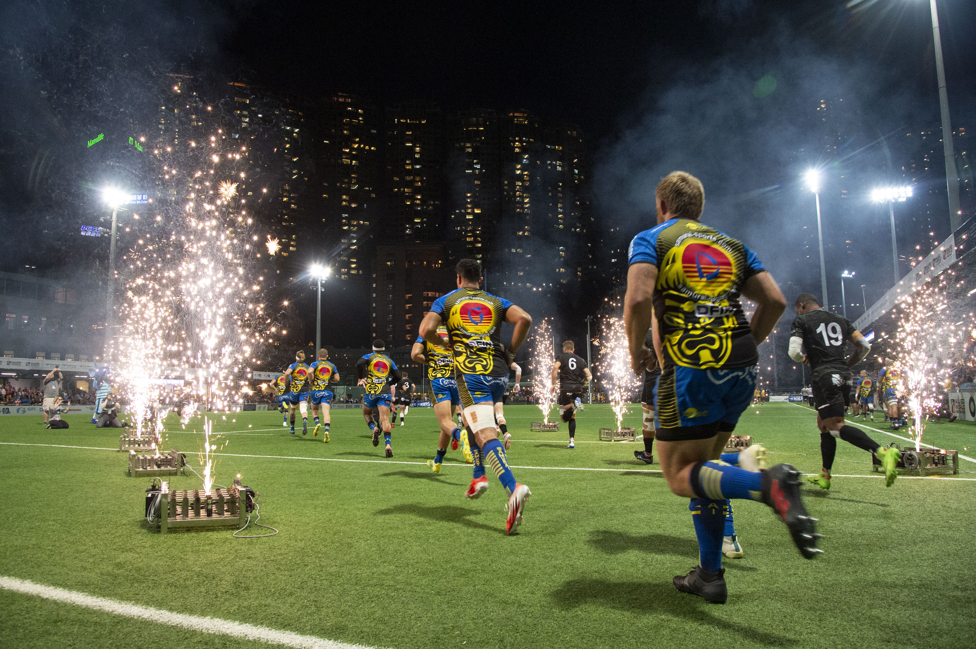 The Samurai International (left) and Biarritz Gavekal players run onto the pitch for the final of the 2019 HKFC 10s. Photo: Handout