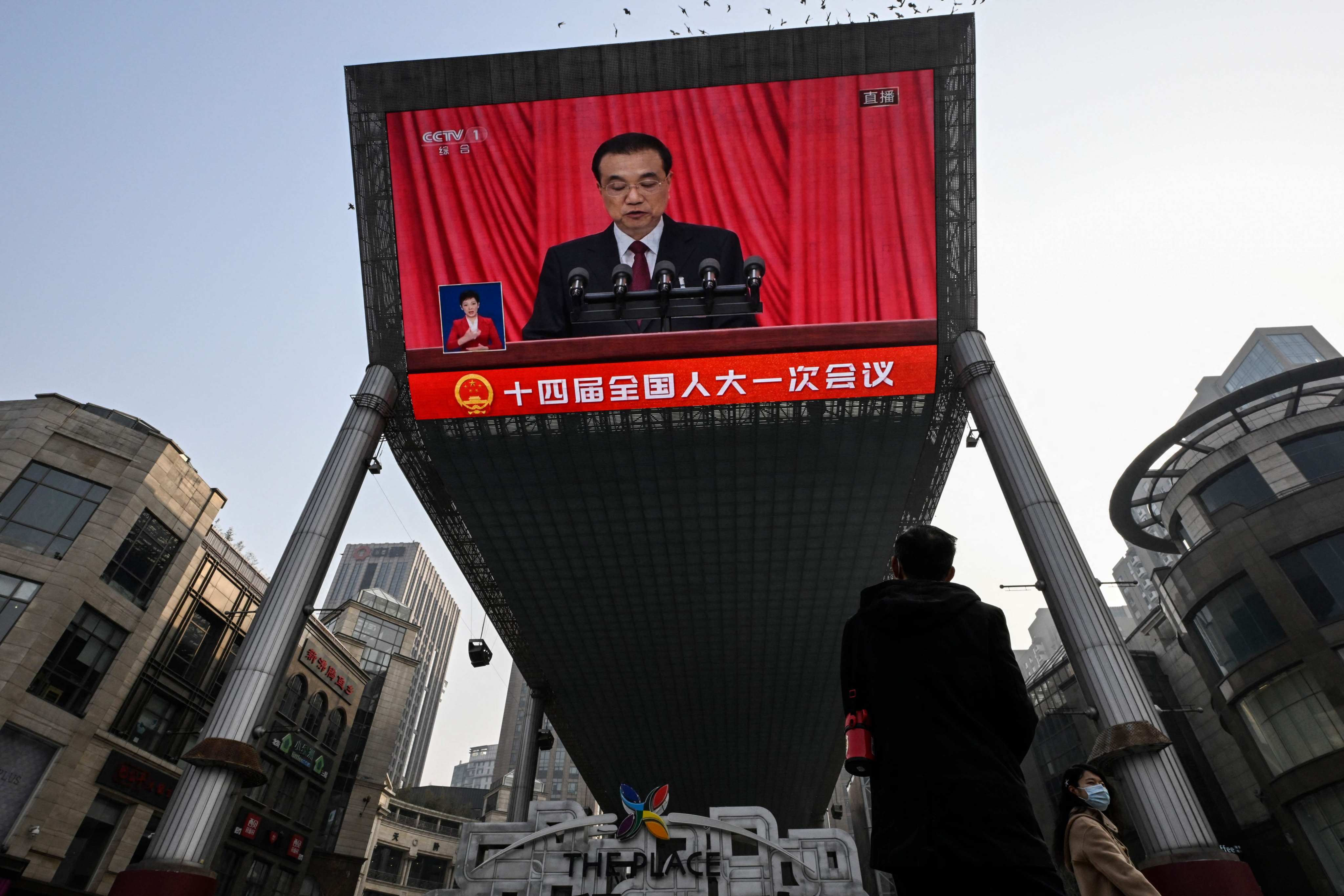 A large outdoor screen in Beijing shows Premier Li Keqiang delivering a work report during the opening session of the National People’s Congress on Sunday. Photo: AFP