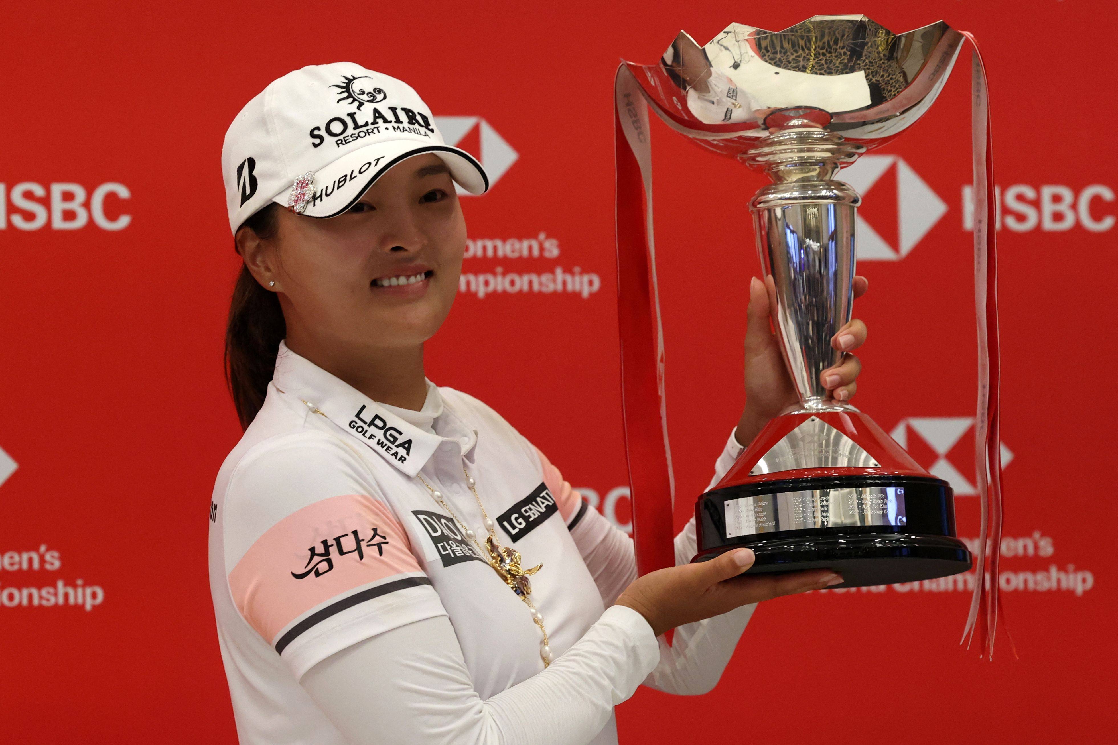 Ko Jin-young of South Korea celebrates with the trophy at Sentosa Golf Club. Photo: AFP