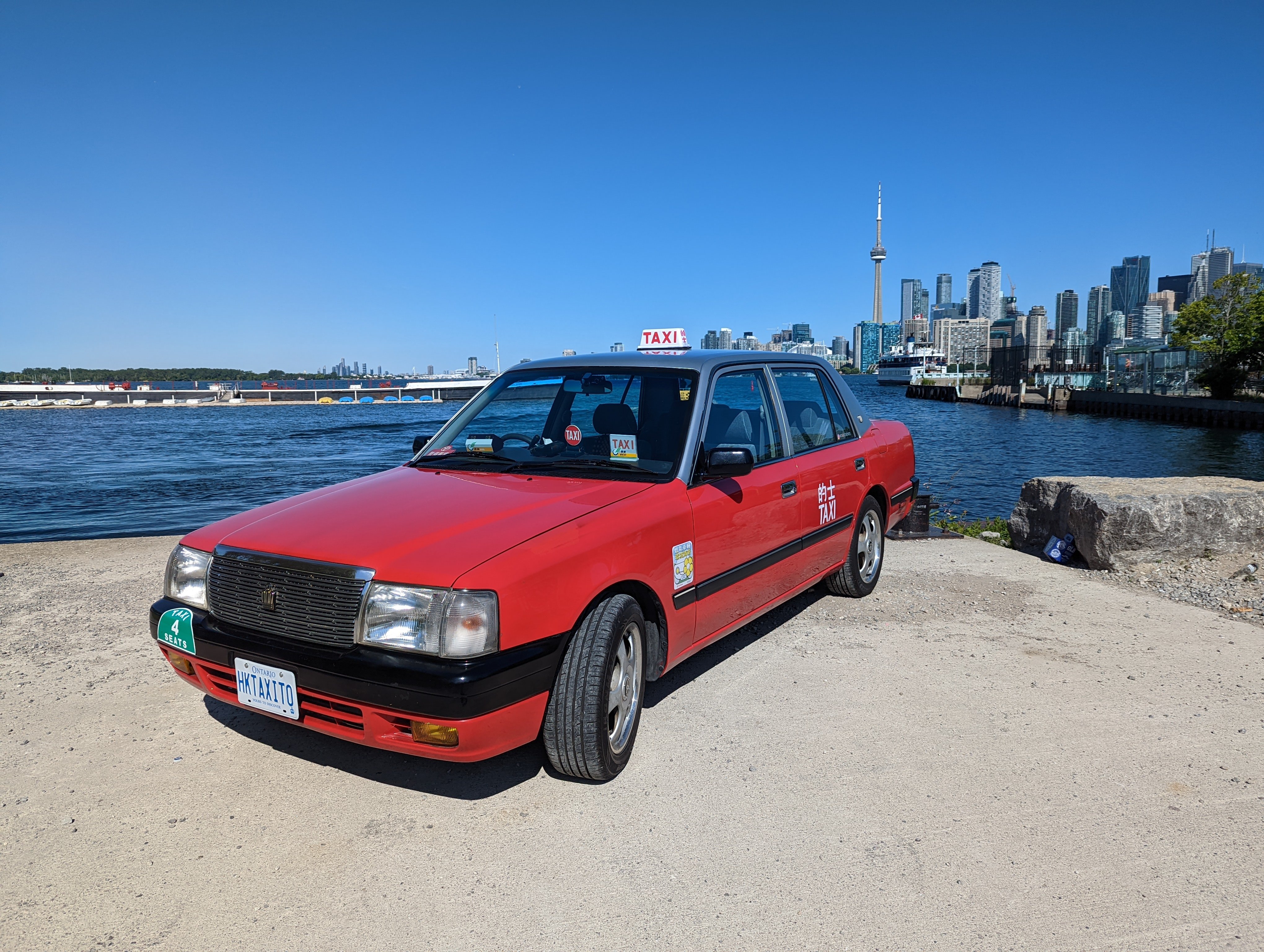 Realtor Alan Wu’s 1997 Toyota Crown Comfort with the Toronto skyline in the background. He bought the Toyota Crown Comfort, once used in the movie Pacific Rim as a prop, refurbished it and added additional components such as a fare meter to make it look more realistic. Photo:  Alan Wu