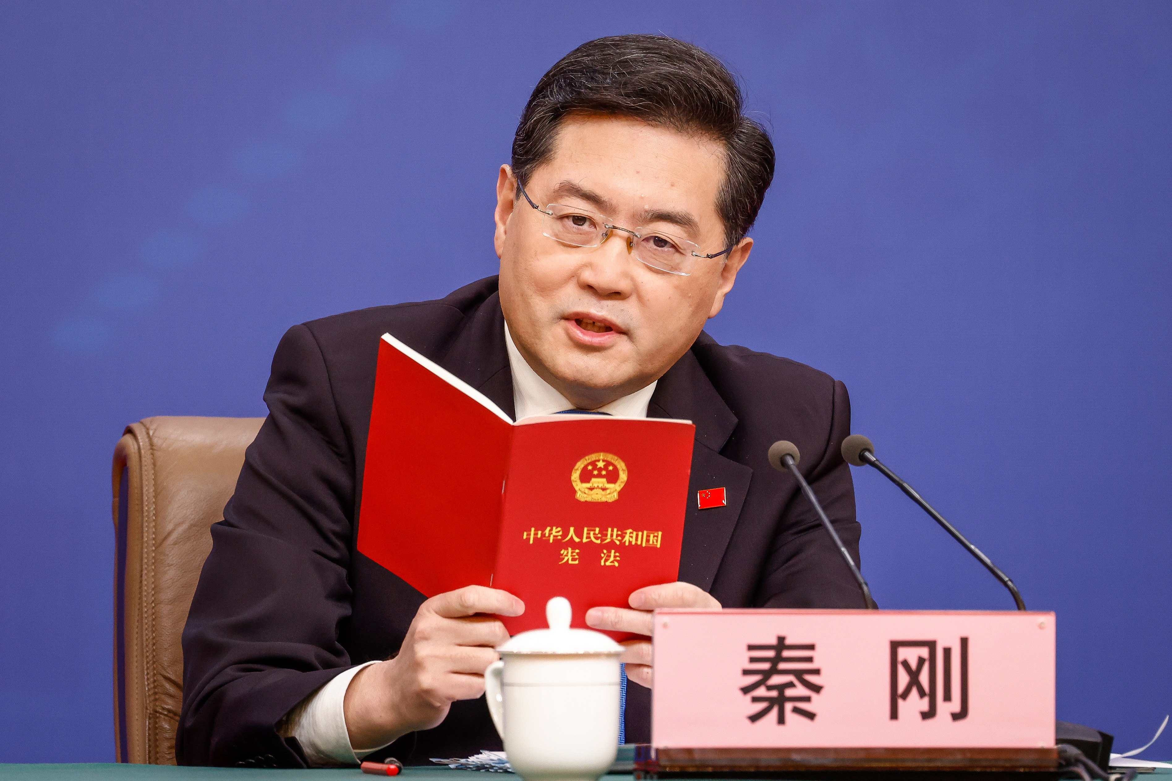 Chinese Foreign Minister Qin Gang reads from China’s constitution after a question about Taiwan during a press conference in Beijing on Tuesday. Photo: EPA-EFE