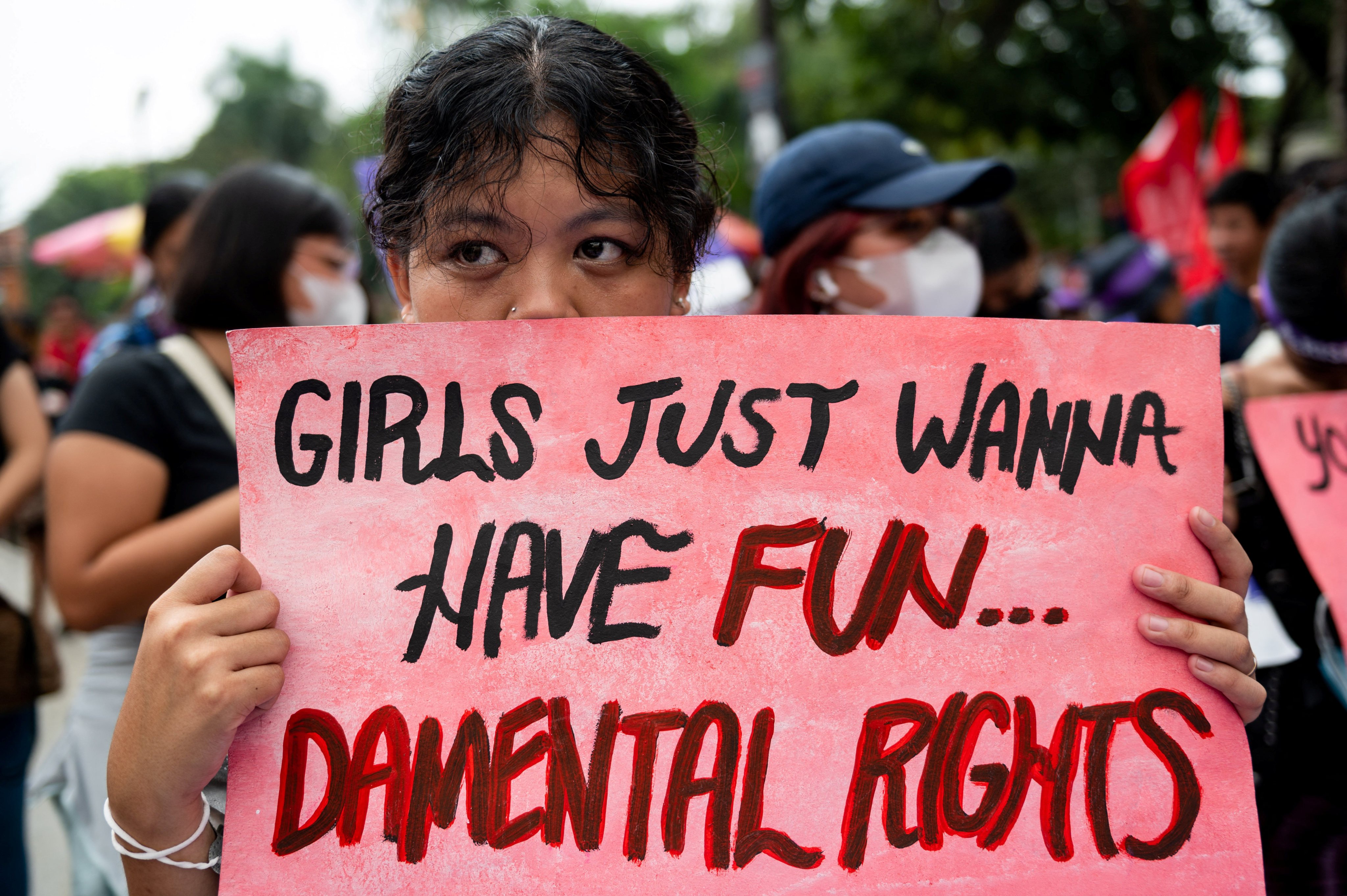 A Filipino activist holds a placard during a protest on Women’s Day in Manila. Photo: Reuters