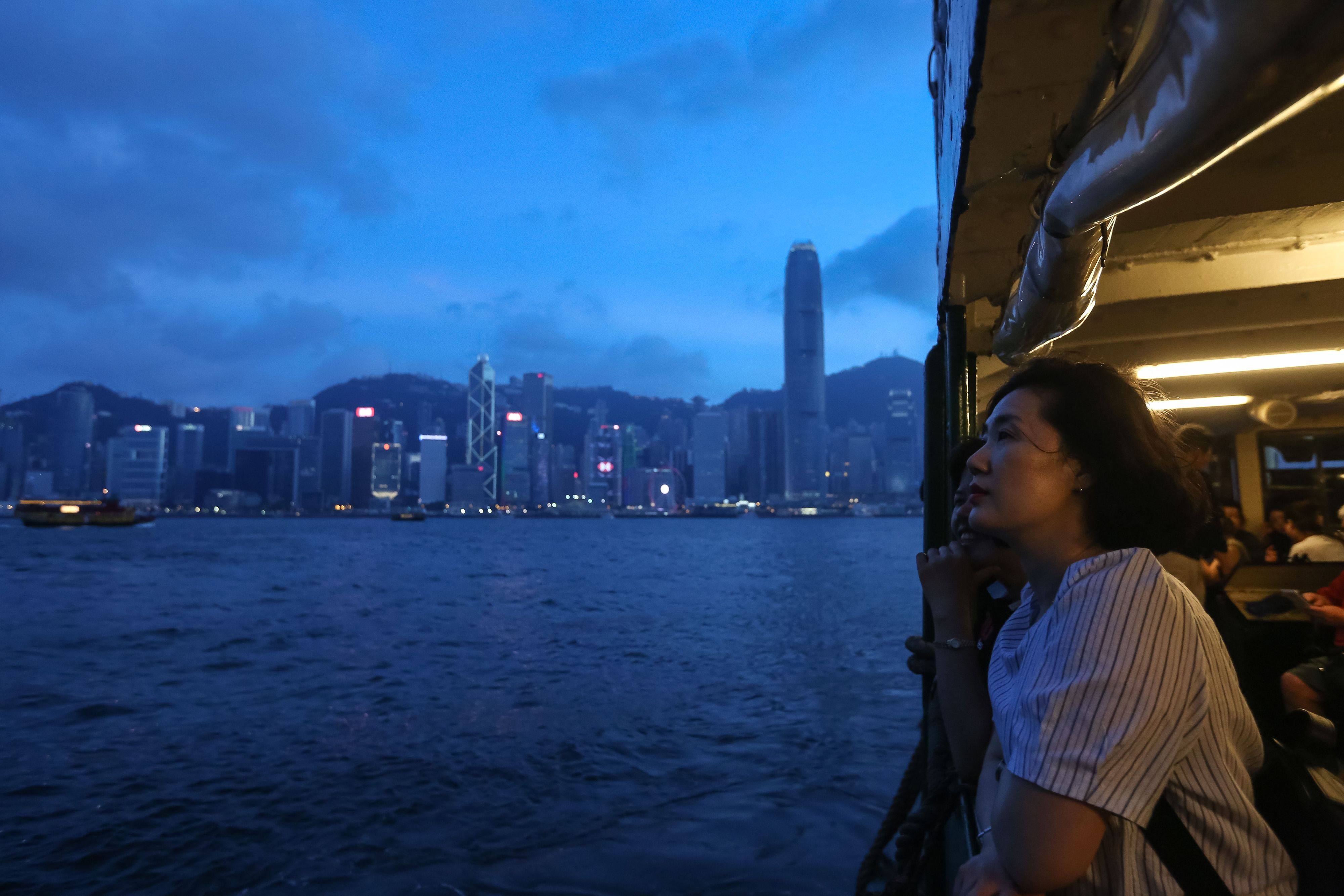 A woman looks out from the Star Ferry with the skyline of Hong Kong’s business district in the background, in June 2018. Photo: AFP 
