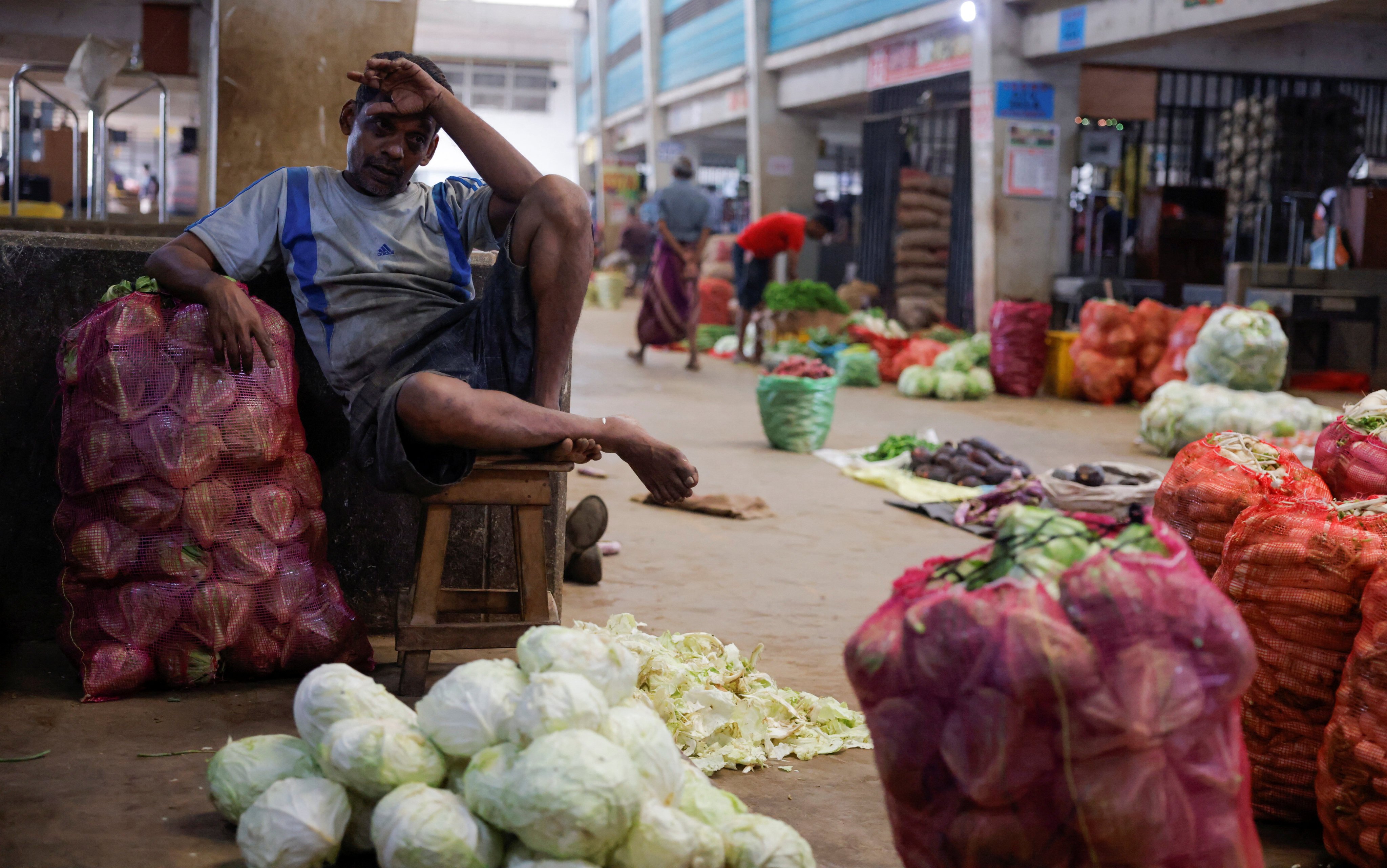 A vendor waits for customers at his vegetable stall at a main market in Colombo, Sri Lanka, in February 2023. Photo: Reuters