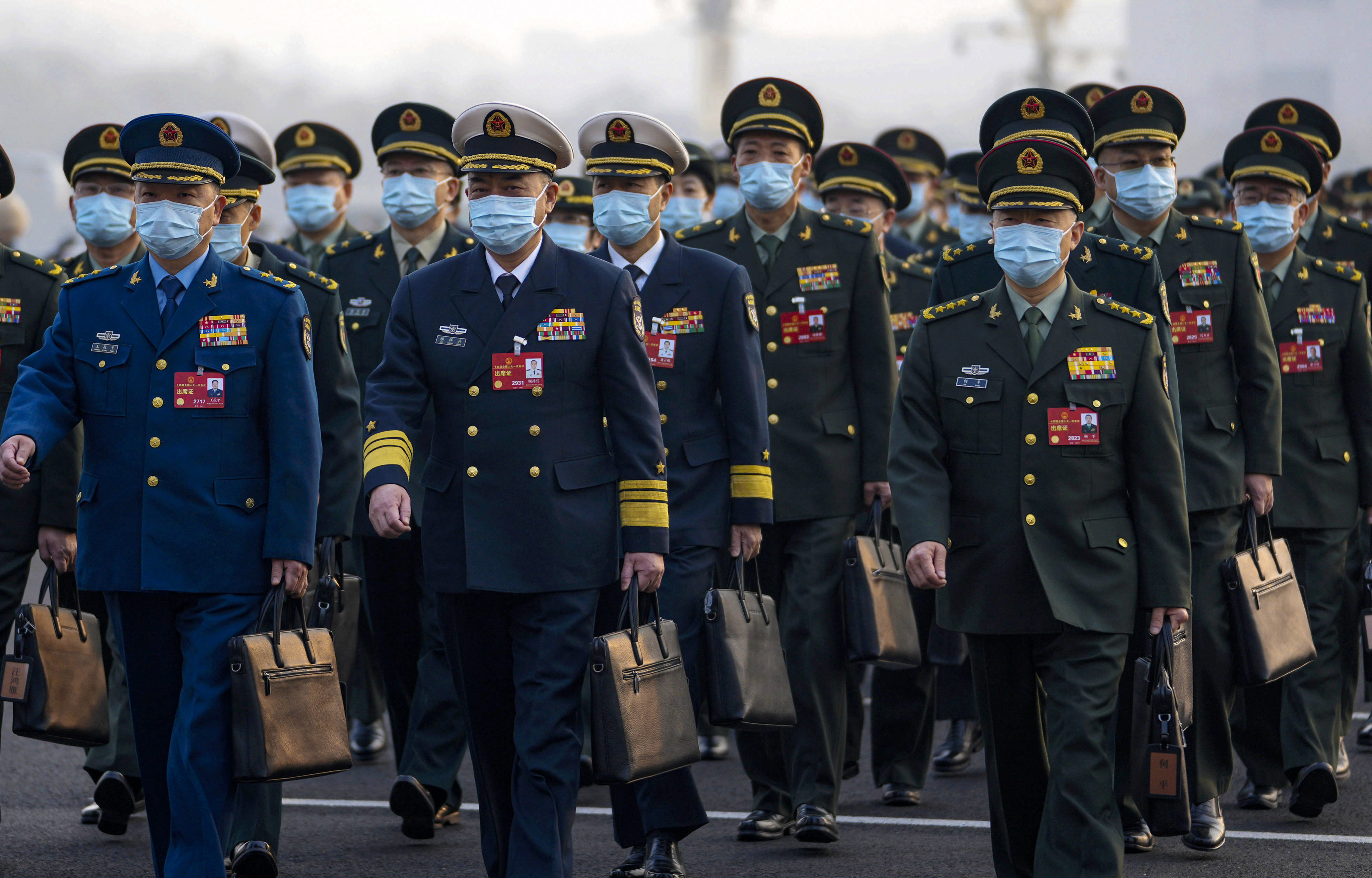Military deputies arrive for the opening session of the  National People’s Congress in Beijing on Sunday. Photo: AP