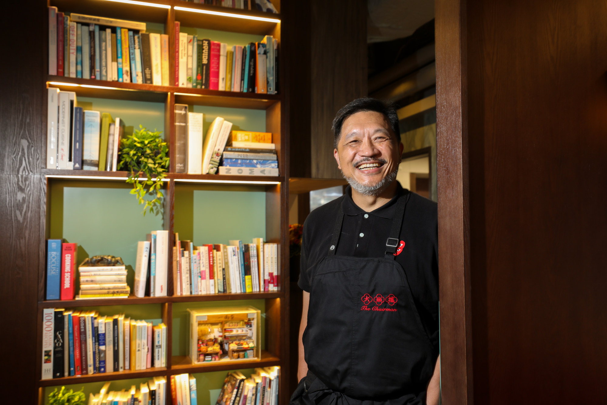Danny Yip Kwok-cheung, founder of The Chairman, at his restaurant in Central. The dining room is anchored around an impressive collection of books. Photo: Xiaomei Chen