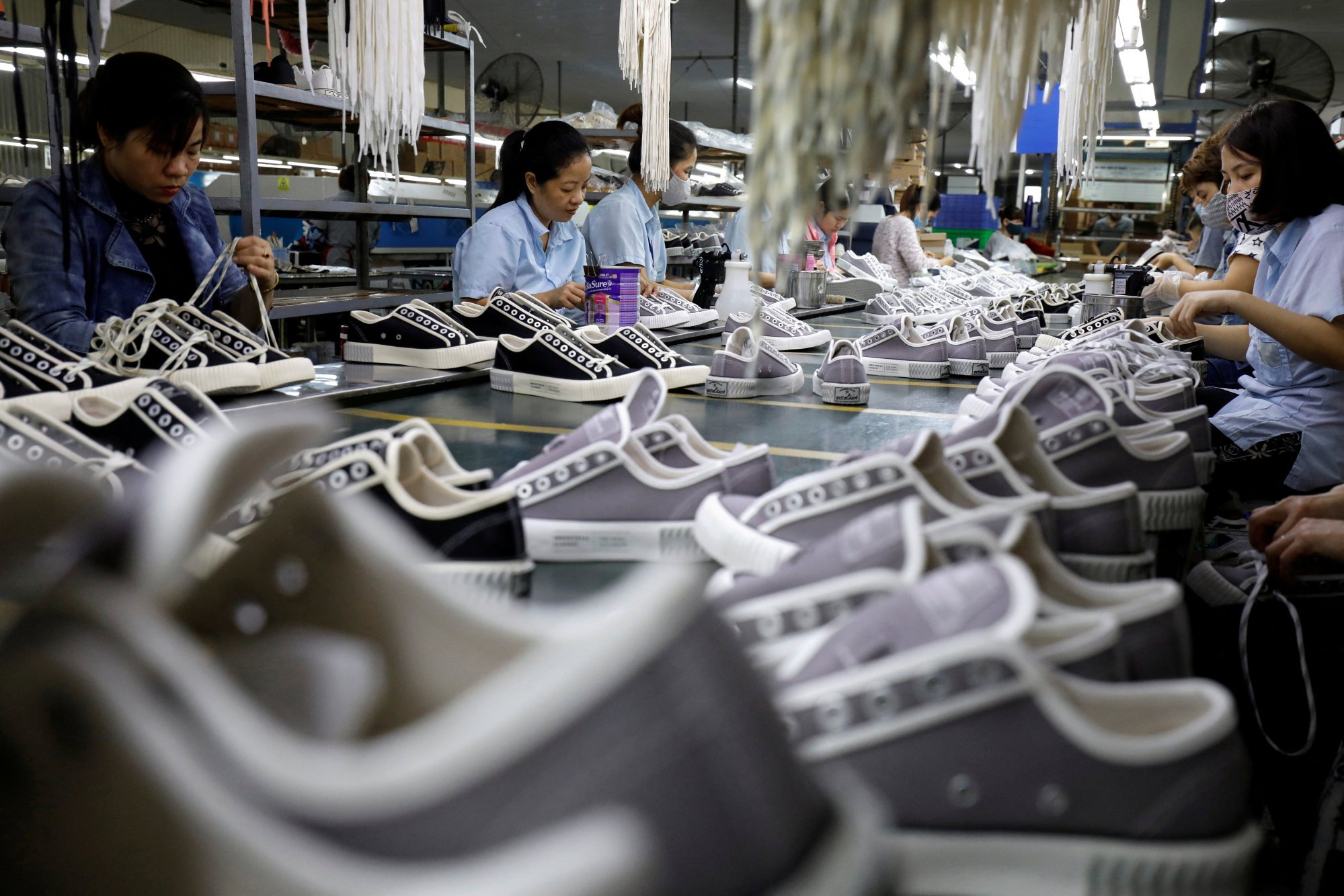 Employees work at a shoe factory for export in Hanoi. Vietnam has become a base for global supply chains such as those of Nike and Apple. Photo: Reuters