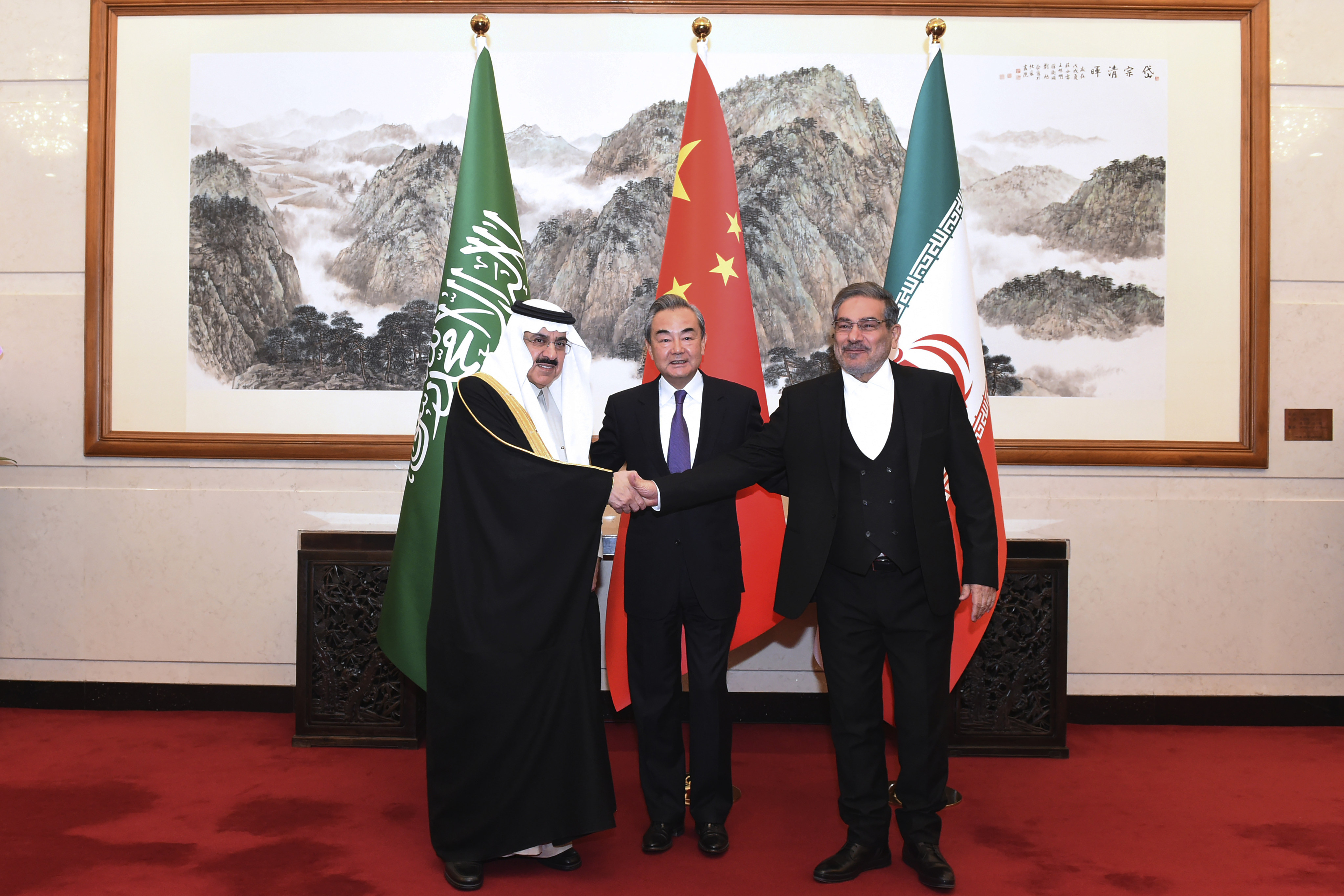 Ali Shamkhani (right), the secretary of Iran’s Supreme National Security Council, shakes hands with Saudi Arabian national security adviser Musaad bin Mohammed al-Aiban (left) as China’s top diplomat Wang Yi looks on in Beijing on Saturday. Photo: Xinhua