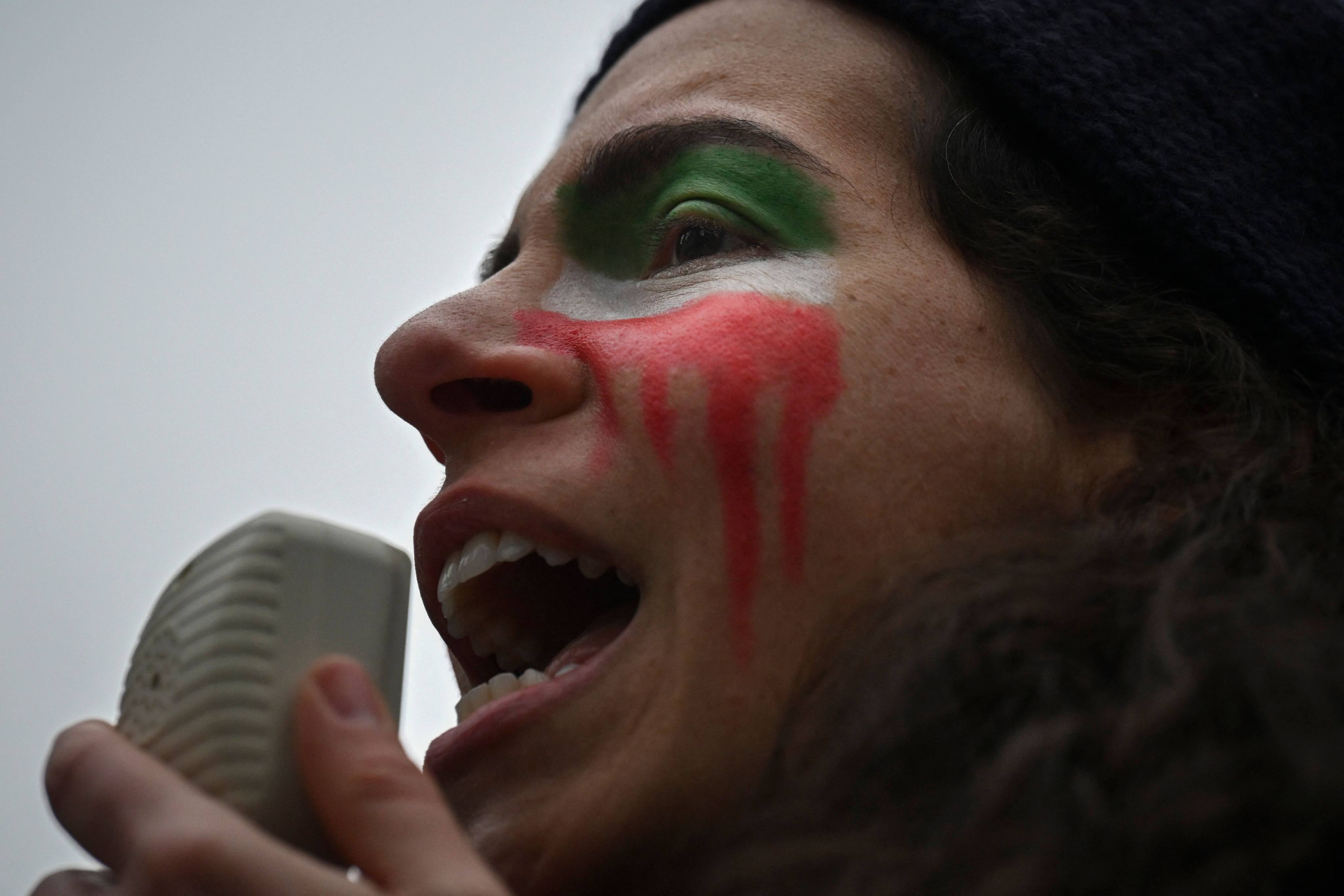 An activist from a New York-based Iranian women’s rights group at a Saturday rally condemning the mass poisoning of female students in Iran. Photo: AFP