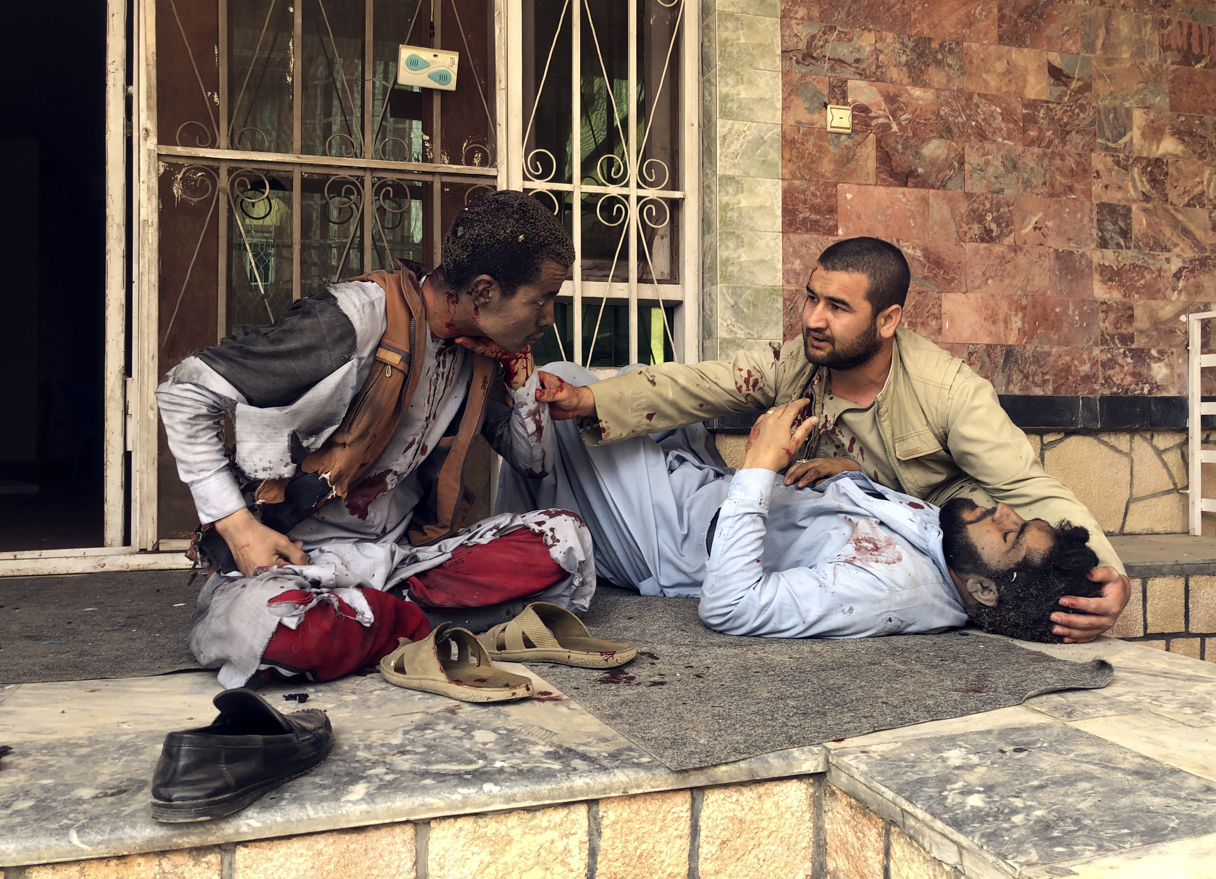 An injured man lies down after a bomb blast in Mazar-i-Sharif, the capital city of Balkh province, in northern Afghanistan on Saturday. Photo: AP