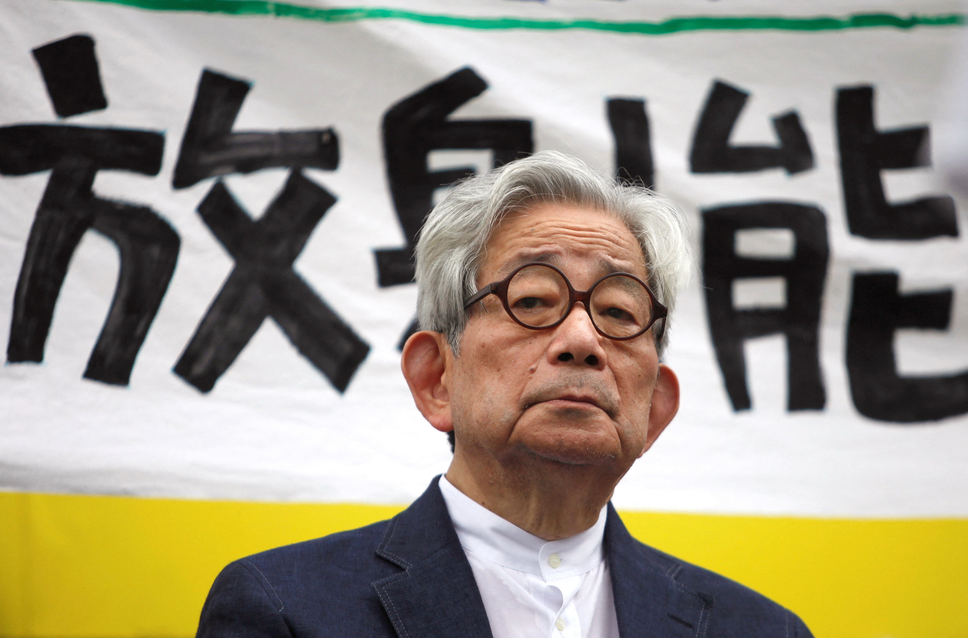 Japanese Nobel literature prize winner Kenzaburo Oe sits in front of a banner reading “radiation” during an anti-nuclear gathering in Tokyo, Japan on September 19, 2011. Photo: Reuters