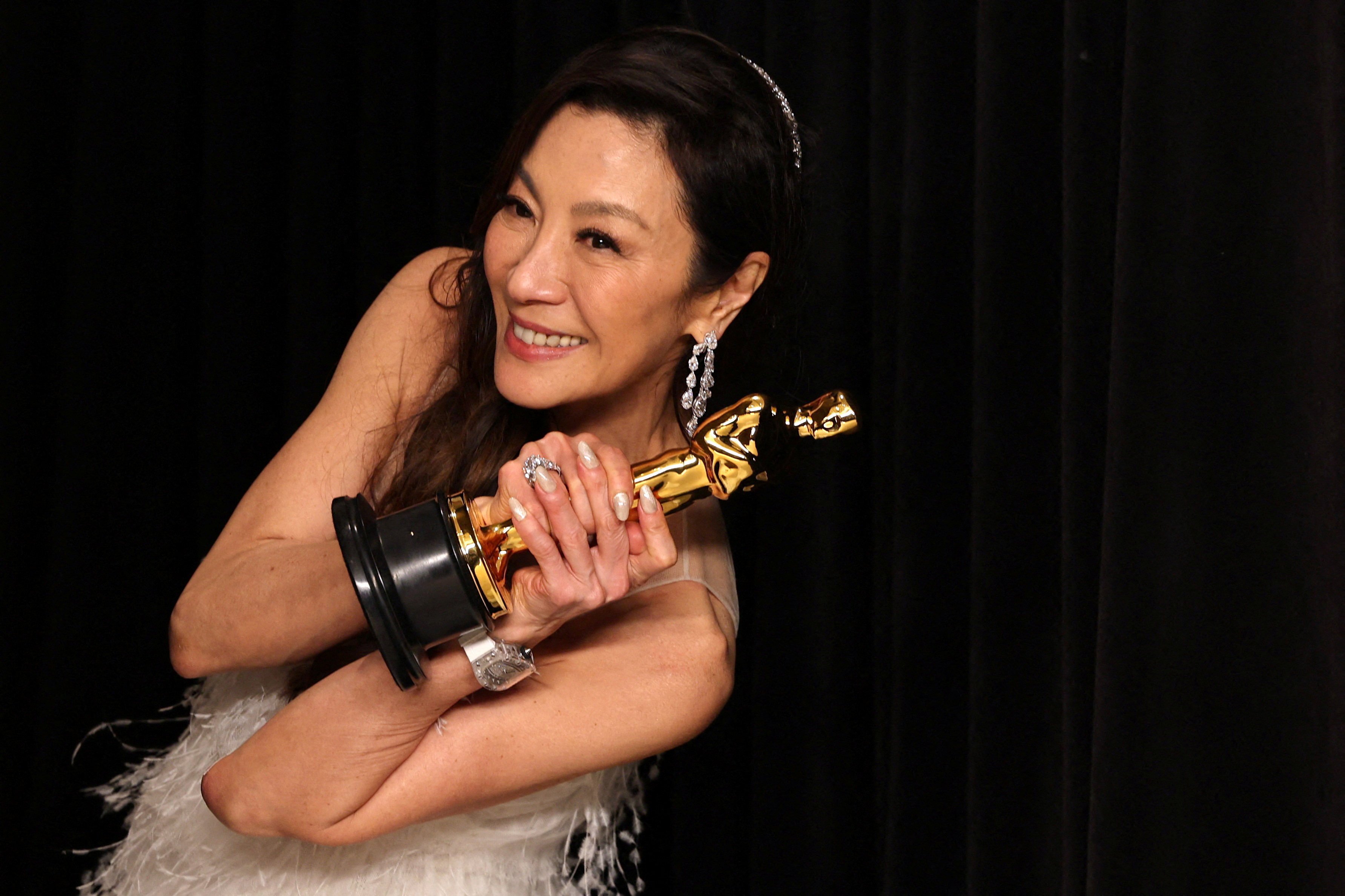 Best actress Michelle Yeoh poses with her Oscar backstage at the Academy Awards in Hollywood, Los Angeles, after becoming the first Asian to win in the category in the 95 years of the Academy Awards. Photo: Reuters