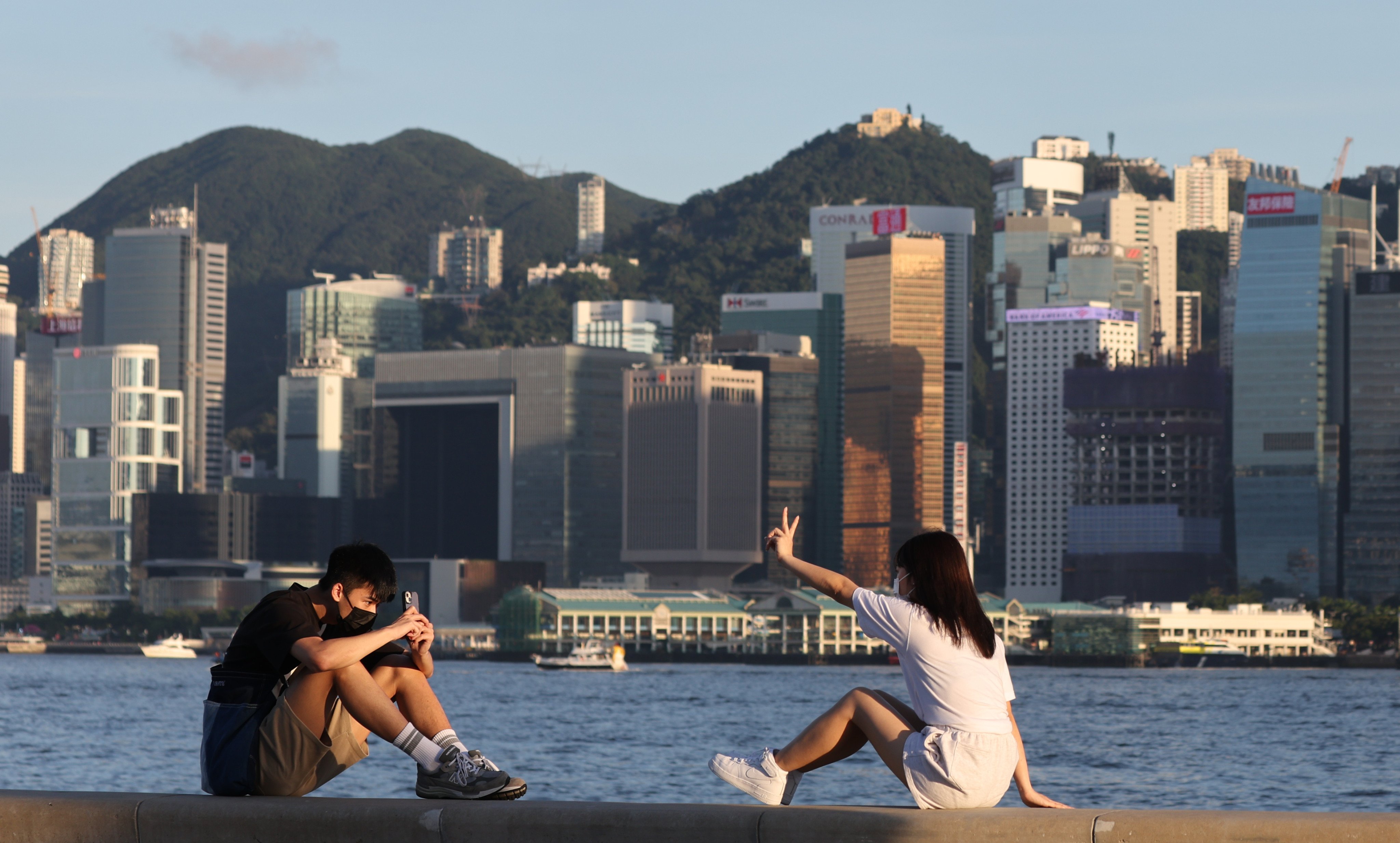 Two young people take a photo at the West Kowloon waterfront promenade in June last year. Like the cohorts before them, today’s youth are worried about ageing populations, resource shortages, climate change and inequalities. Photo: Edmond So