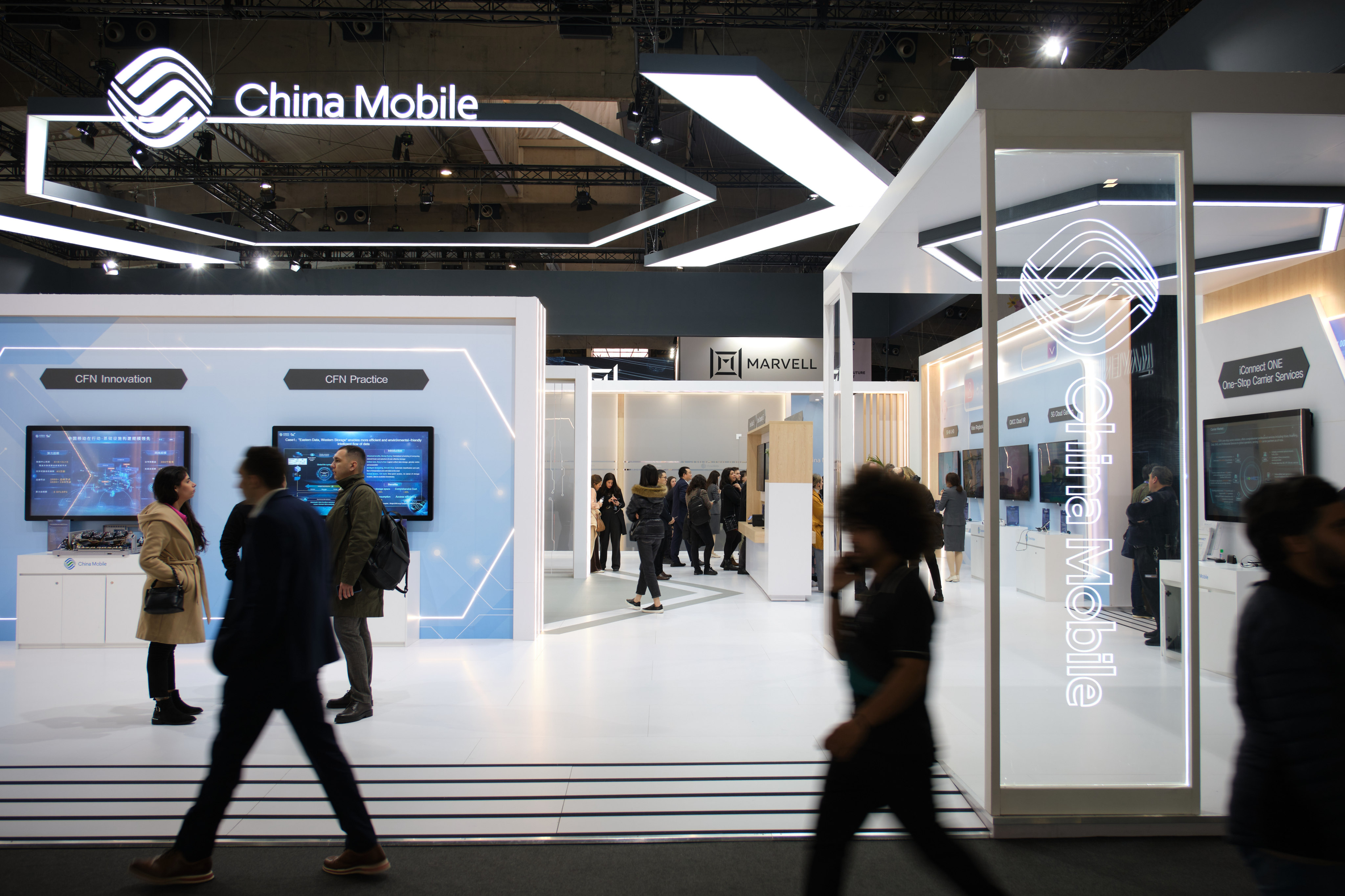 People pass a China Mobile booth at the 2023 Mobile World Congress (MWC) in Barcelona, Spain, on March 1, 2023. Photo: Xinhua