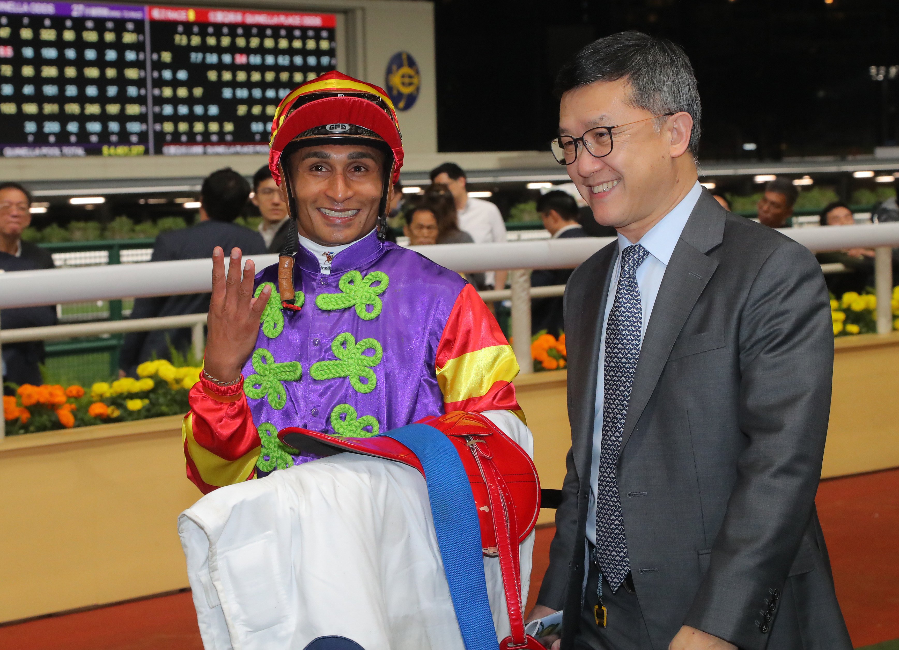 Jockey Karis Teetan celebrates his Happy Valley four-timer with trainer Peter Ho. Photo: Kenneth Chan
