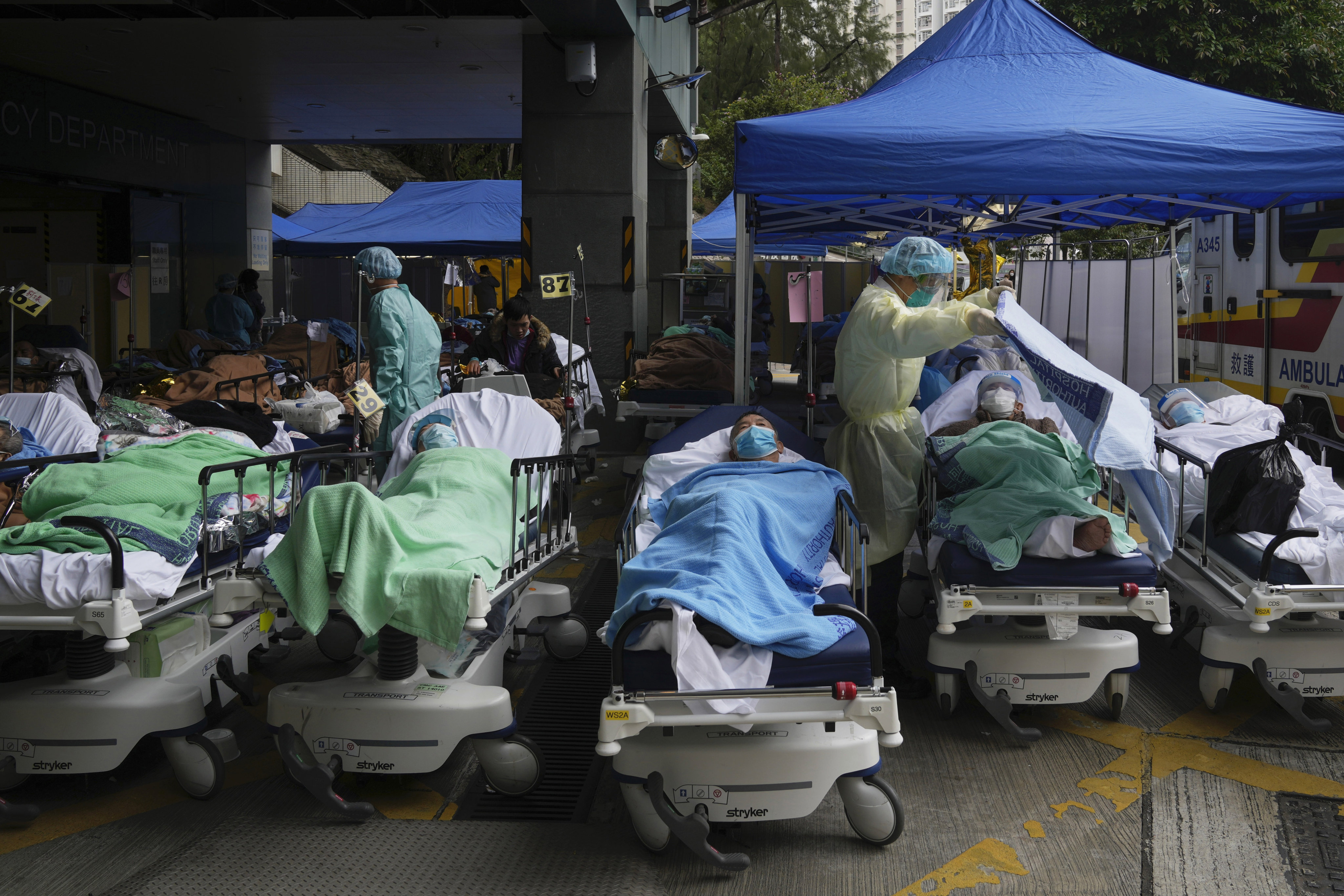 Patients lie on hospital beds as they wait at a temporary makeshift treatment area outside the Caritas Medical Centre in Sham Shui Po on February 18, 2022. Hong Kong’s experience during the fifth wave of the Covid-19 pandemic showed the importance of local experts producing timely research, something that can strengthen the city’s push to be a biomedical innovation hub and inform national policymaking. Photo: AP
