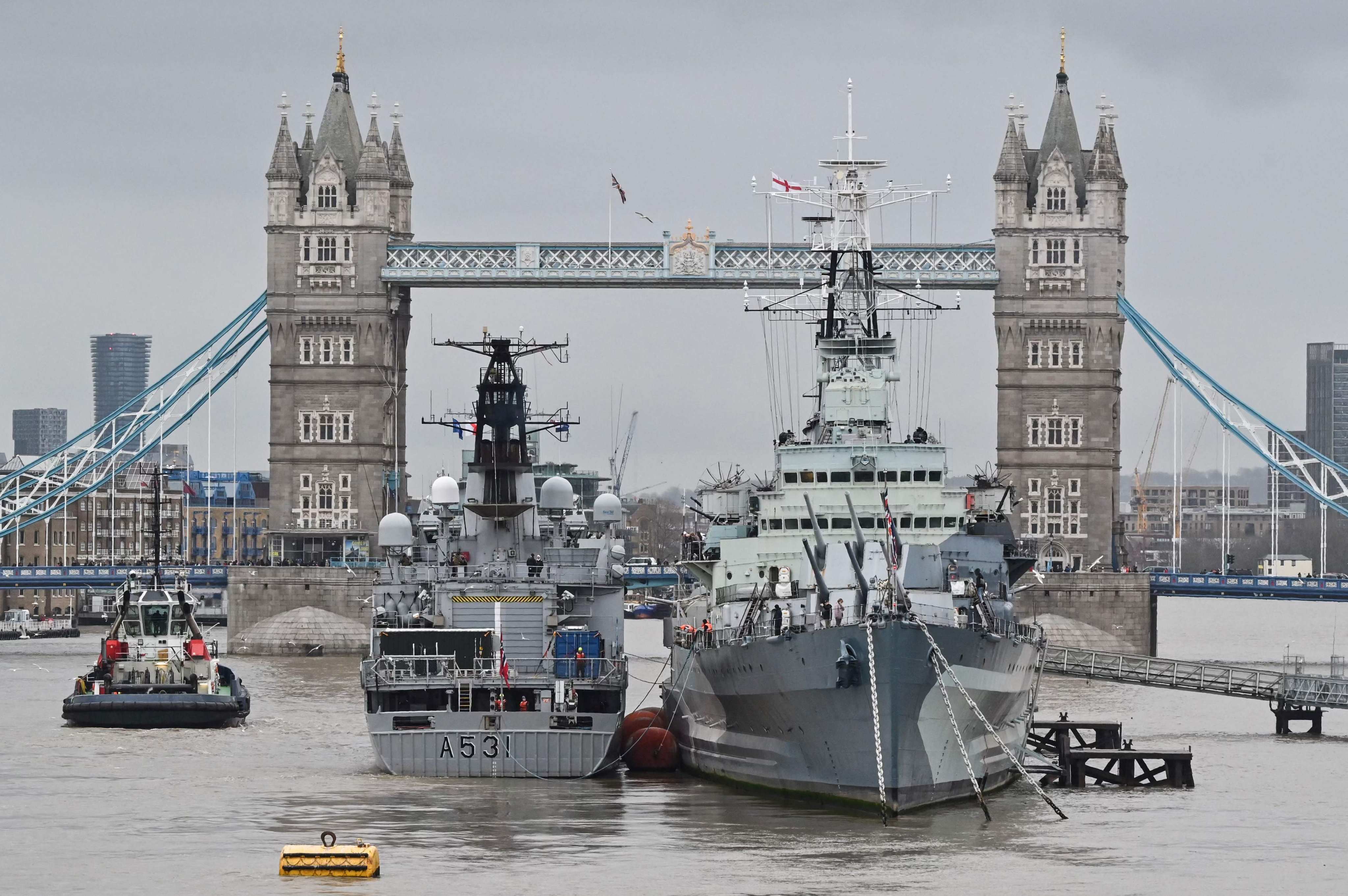 The Norwegian-flagged Nato warship A531 is moored next to HMS Belfast, a historic warship and museum, on the Thames in central London on February 23. Photo: AFP