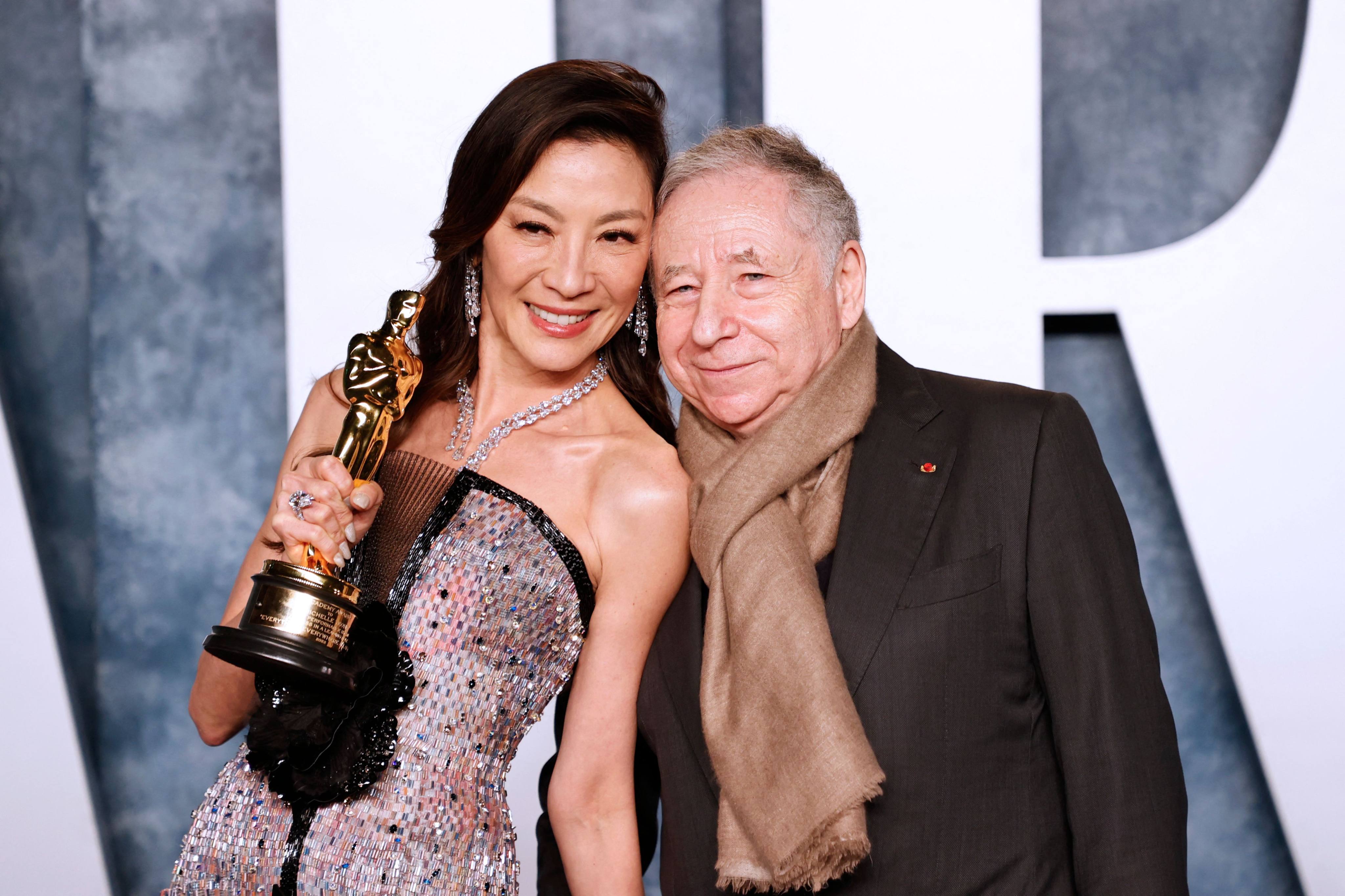 Malaysian actress Michelle Yeoh and French motor racing executive Jean Todt pose for photos after her win at the 95th Academy Awards after party. Photo: AFP