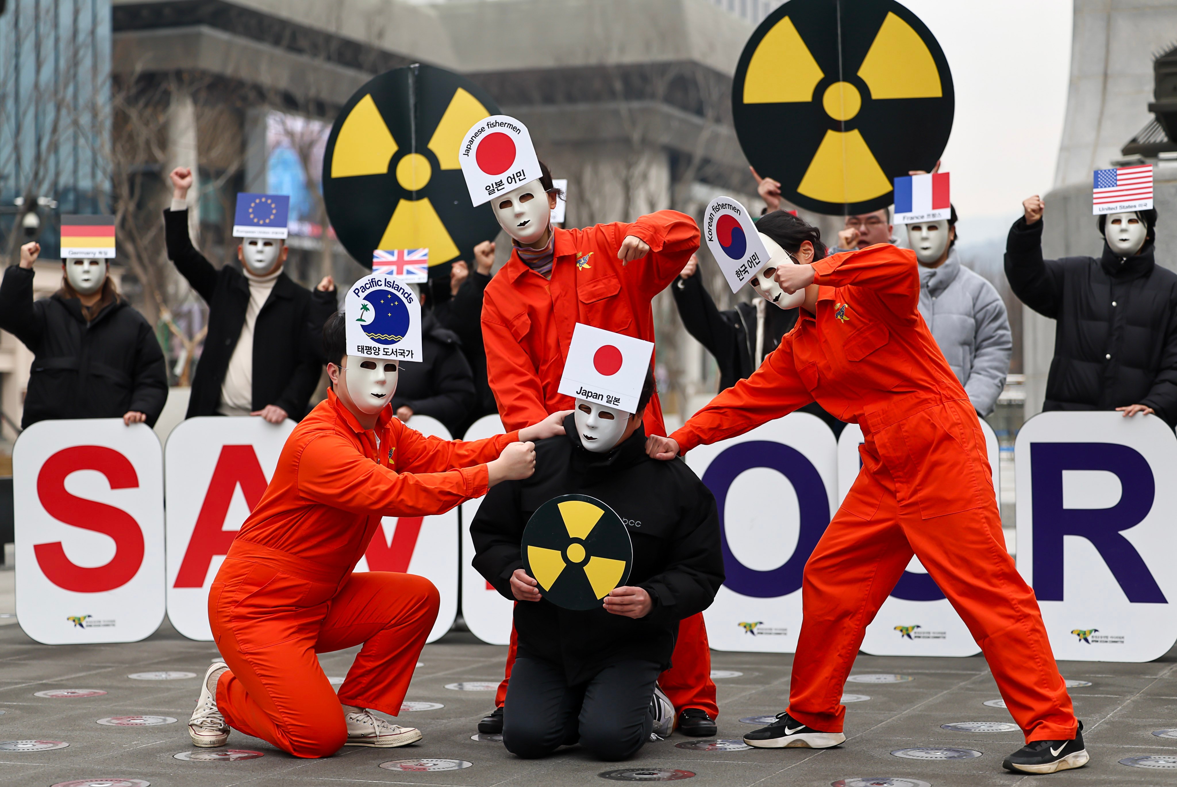 Environmental activists give a performance calling for Japan to call off its decision to release treated waste water from the crippled Fukushima nuclear power station into the sea, during a rally in Seoul, South Korea, on February 28. Photo:  EPA-EFE