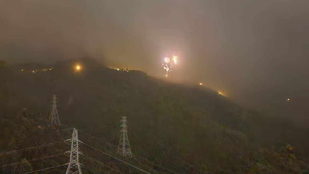 Flames on an electricity pylon on Kowloon Peak light up the hillside. Photo: Handout