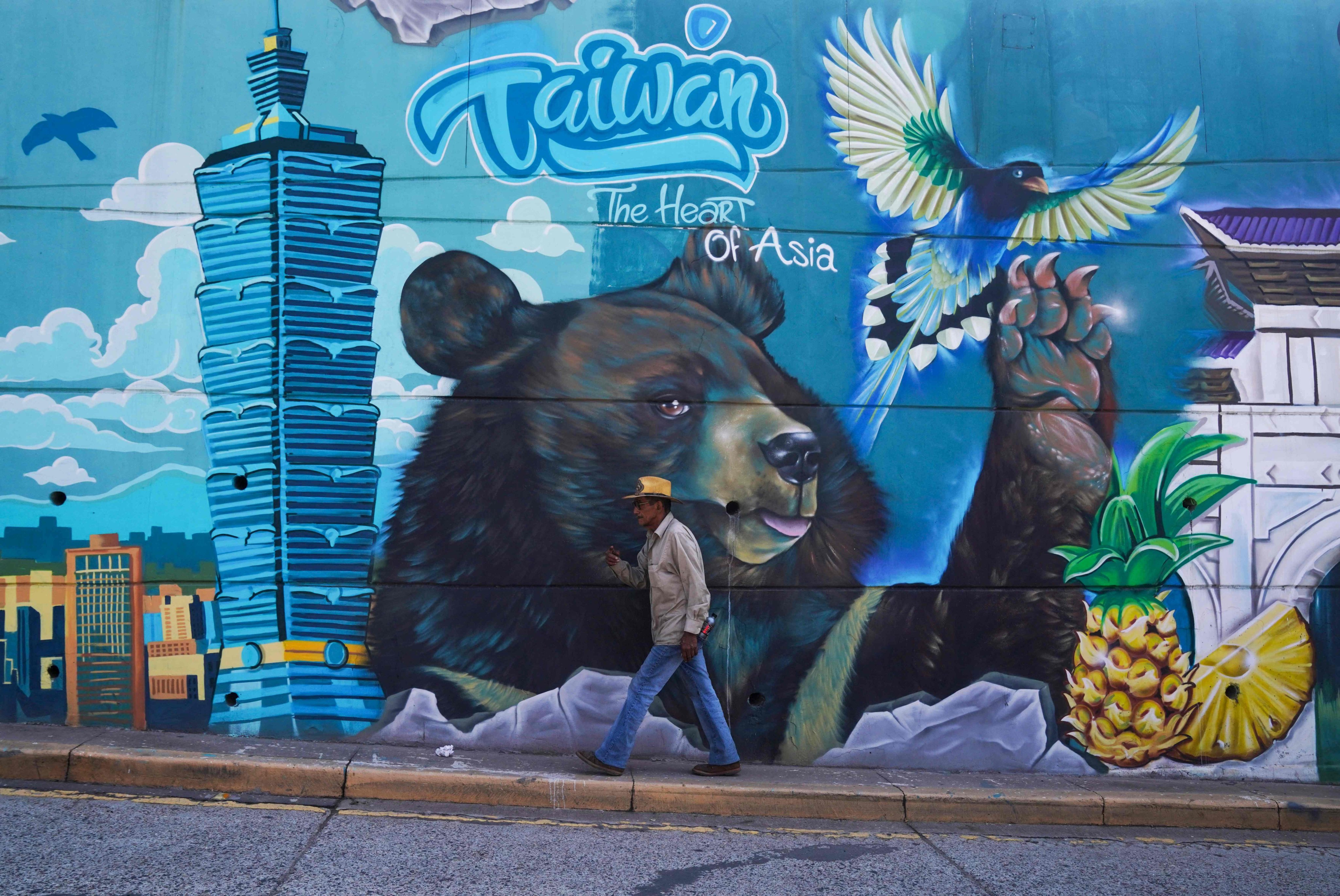 A man walks past a mural alluding to Taiwan in Tegucigalpa, the capital of Honduras, on Wednesday. Photo: AFP